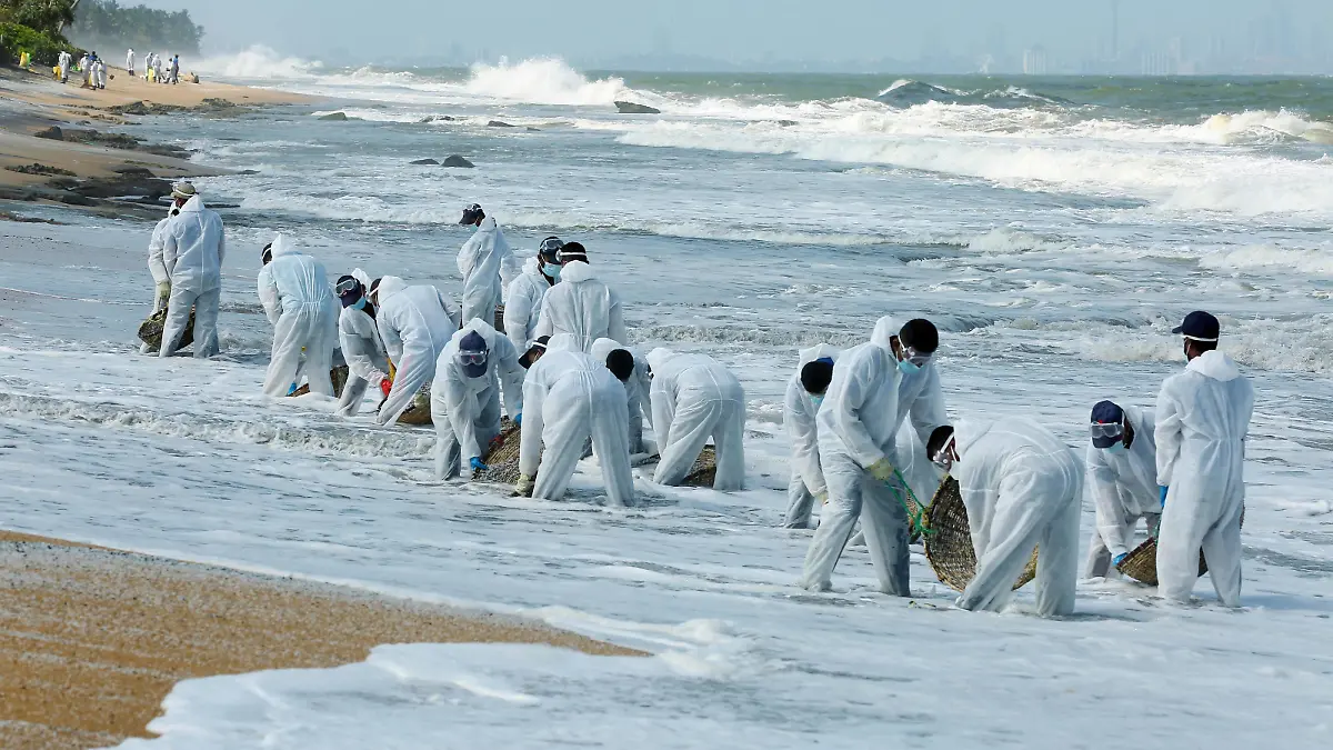 210602 -- COLOMBO, June 2, 2021 -- Sri Lankan security personnel remove debris of X Press Pearl, a burnt and sinking container vessel, from the beach in Colombo, Sri Lanka, June 2, 2021. The Marine Environment Protection Authority said that the burning of the X Press Pearl vessel had caused a massive environmental disaster as beaches from the south coast to the western coast had been damaged due to the debris which was washed ashore. TO GO WITH Sri Lanka halts towing burnt X Press Pearl ship Photo by /Xinhua SRI LANKA-COLOMBO-SINKING VESSEL-DEBRIS CLEANING AjithxPerera PUBLICATIONxNOTxINxCHN
