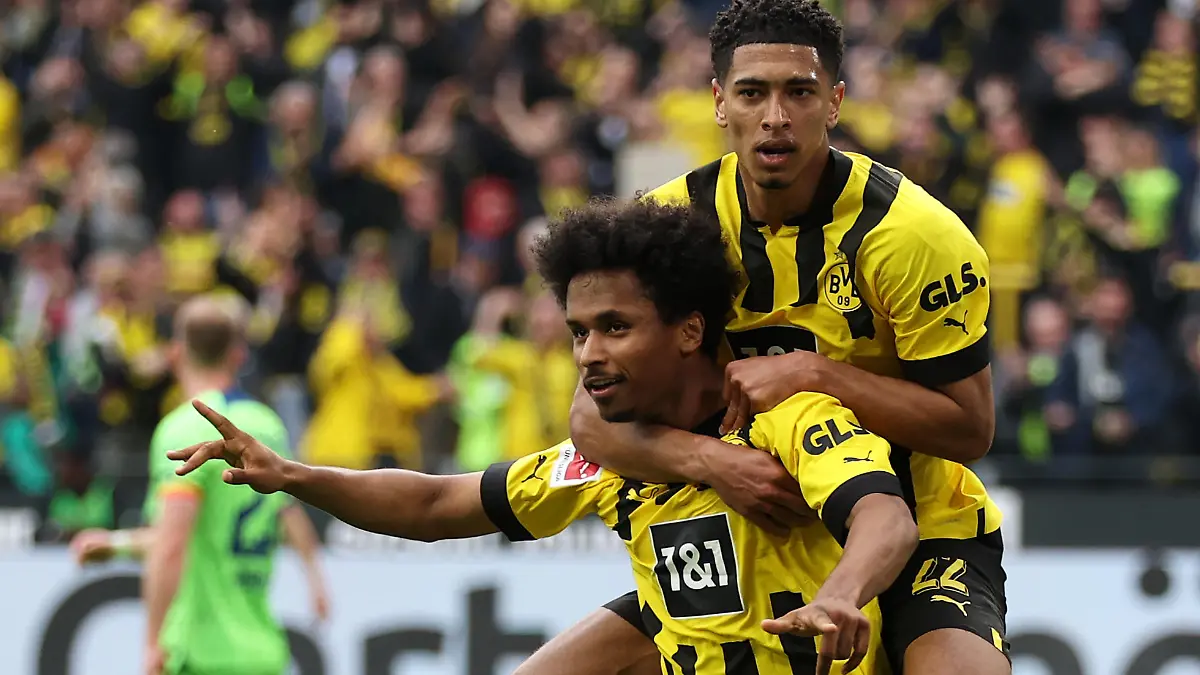DORTMUND, GERMANY - MAY 07: Karim Adeyemi of Borussia Dortmund celebrates with teammate Jude Bellingham after scoring the team's fifth goal during the Bundesliga match between Borussia Dortmund and VfL Wolfsburg at Signal Iduna Park on May 07, 2023 in Dortmund, Germany. (Photo by Lars Baron/Getty Images)