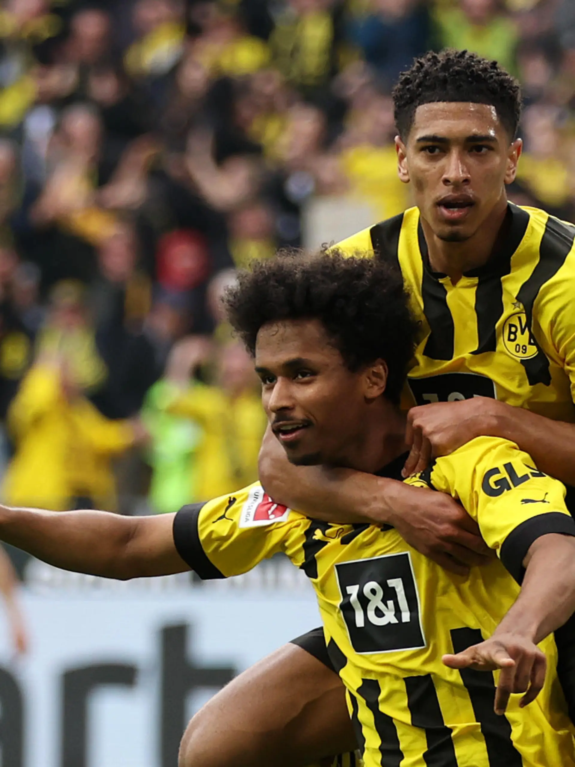 DORTMUND, GERMANY - MAY 07: Karim Adeyemi of Borussia Dortmund celebrates with teammate Jude Bellingham after scoring the team's fifth goal during the Bundesliga match between Borussia Dortmund and VfL Wolfsburg at Signal Iduna Park on May 07, 2023 in Dortmund, Germany. (Photo by Lars Baron/Getty Images)