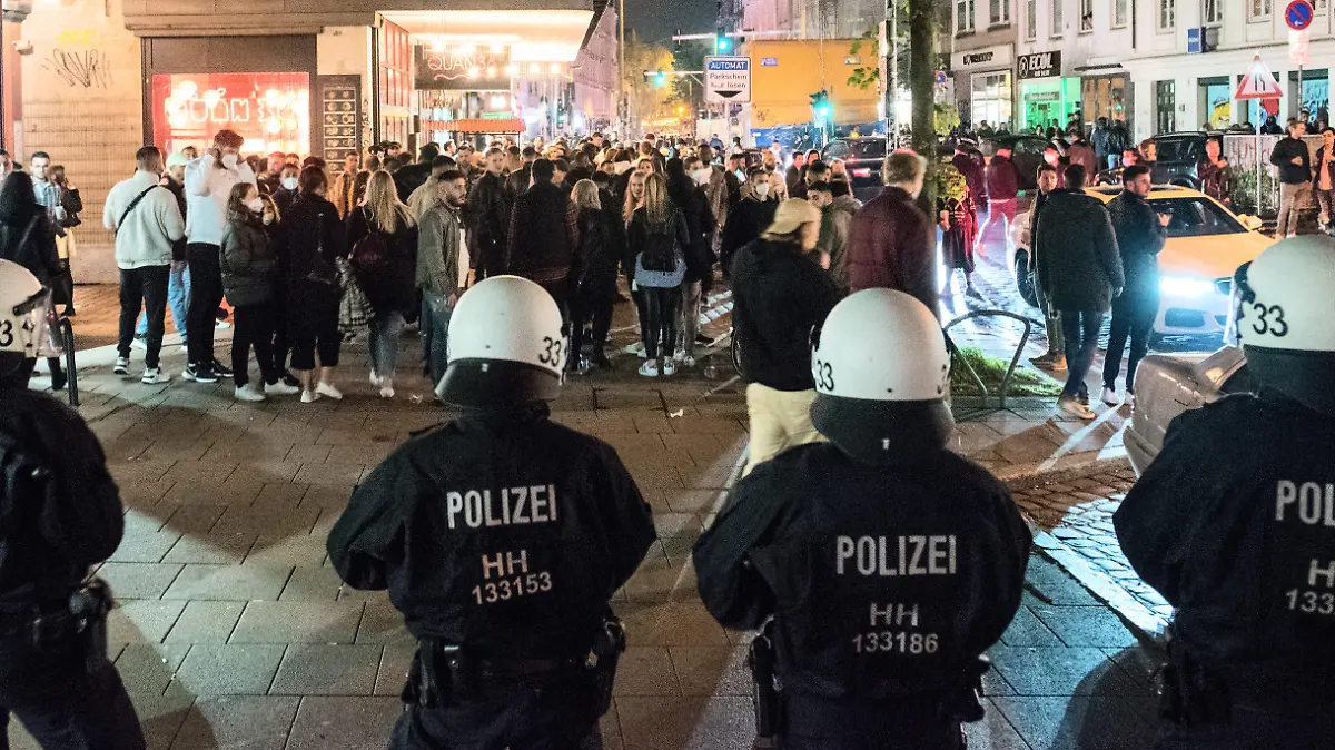 dpatopbilder - 29.05.2021, Hamburg: Polizisten treiben am späten Abend Besucher aus dem Schanzenviertel. Nachdem sich zahlreiche Menschen in Parks und auf den Straßen versammelt hatten, hat die Polizei das Viertel am Abend geräumt und Geschäfte und Gastronomie eher schließen lassen. (Nutzung nur im vollen Format) Foto: Daniel Bockwoldt/dpa +++ dpa-Bildfunk +++