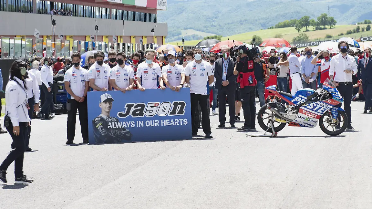 SCARPERIA, ITALY - MAY 30: The paddock family on grid during a minute of silence in order to remember the young rider Jason Dupasquier of Swiss and Carxpert PrustelGP during the MotoGP Of Italy - Race at Mugello Circuit on May 30, 2021 in Scarperia, Italy. (Photo by Mirco Lazzari gp/Getty Images)