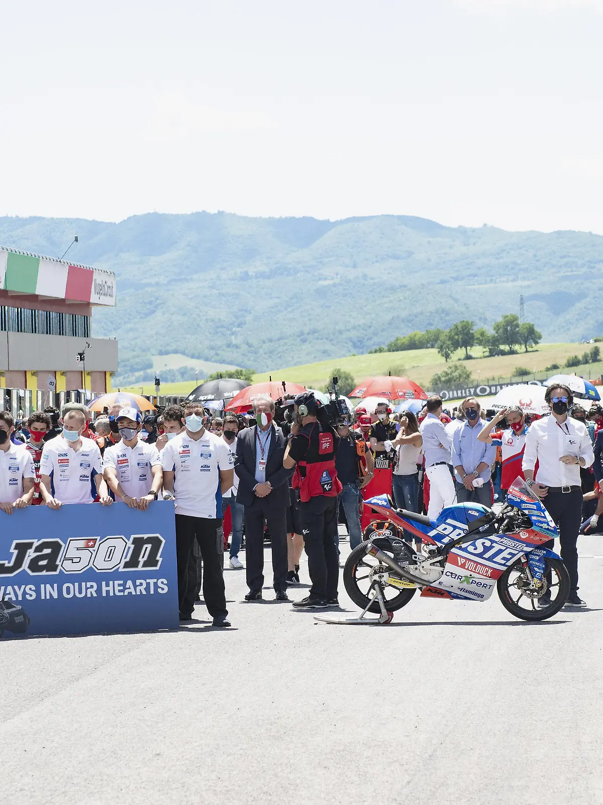 SCARPERIA, ITALY - MAY 30: The paddock family on grid during a minute of silence in order to remember the young rider Jason Dupasquier of Swiss and Carxpert PrustelGP during the MotoGP Of Italy - Race at Mugello Circuit on May 30, 2021 in Scarperia, Italy. (Photo by Mirco Lazzari gp/Getty Images)