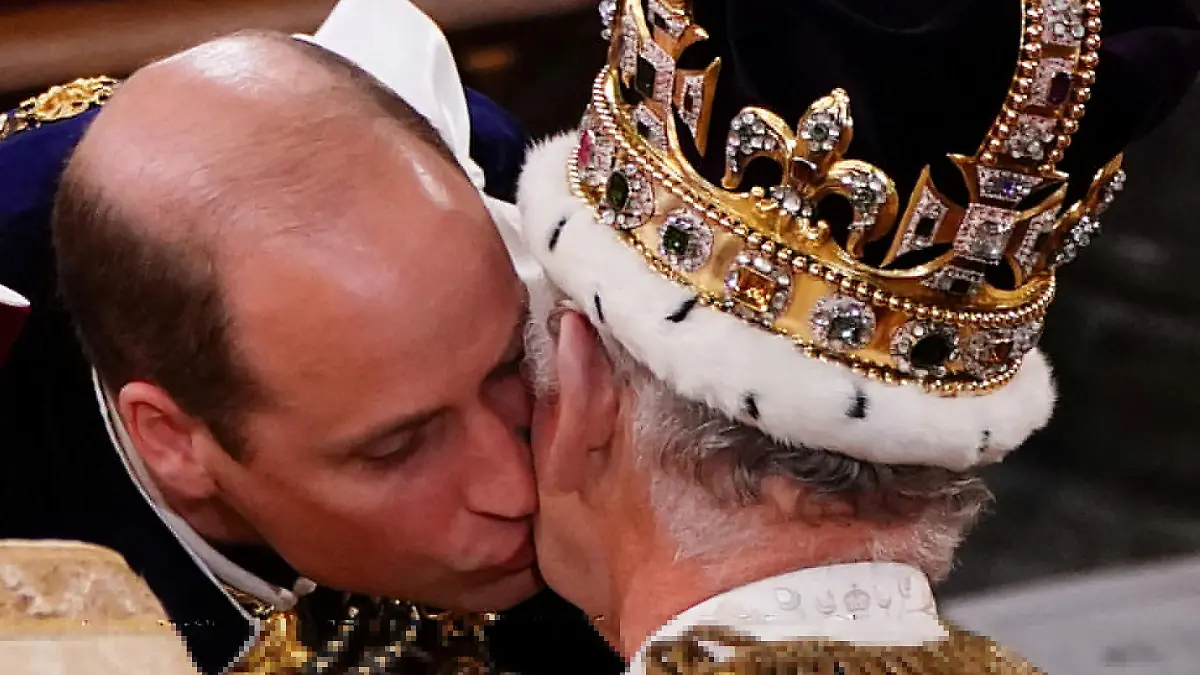 The Prince of Wales kisses his father King Charles III during his coronation ceremony in Westminster Abbey, London. Picture date: Saturday May 6, 2023.    Yui Mok/Pool via REUTERS