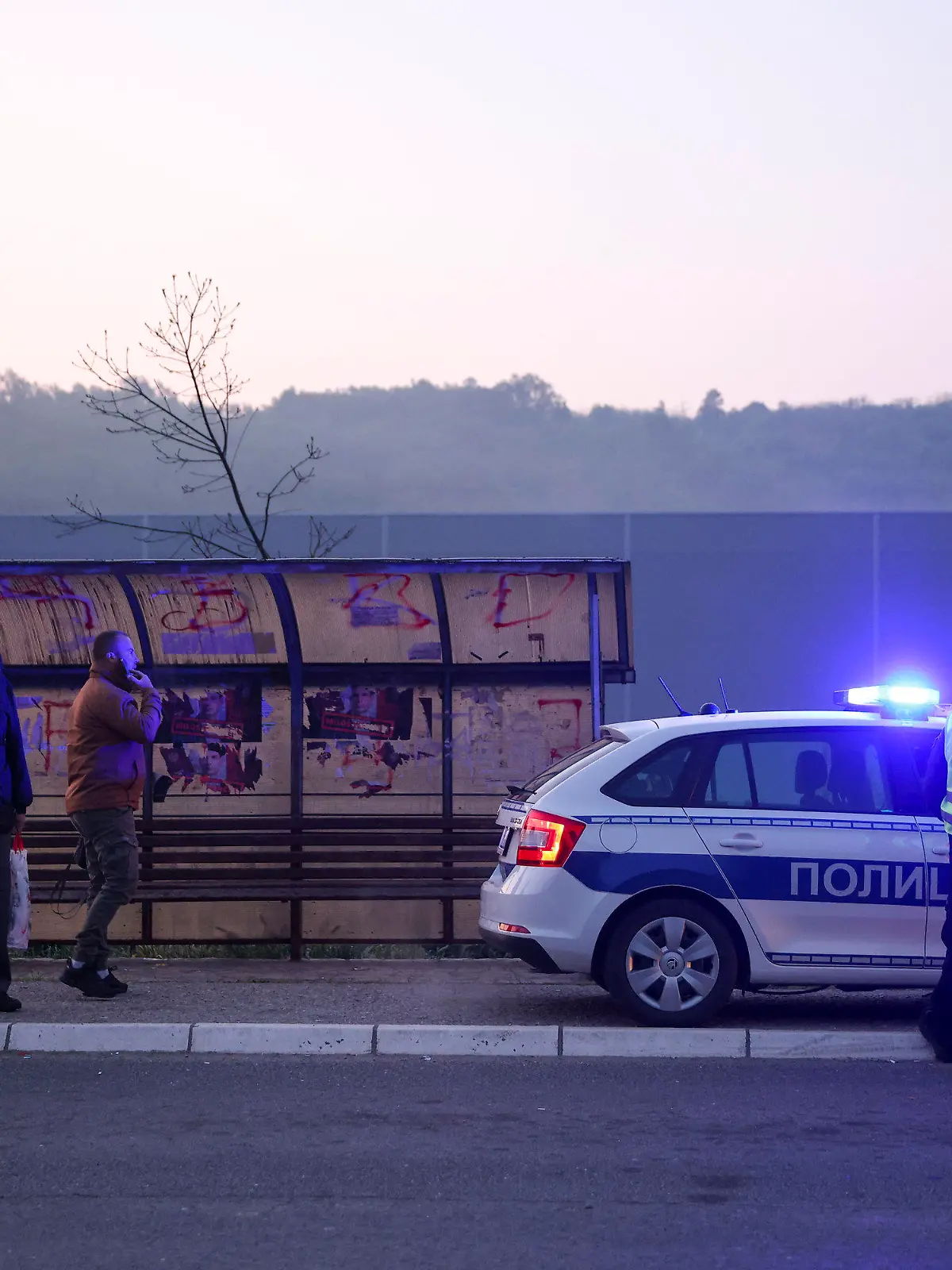 Police officers block the road near the village of Mali Pozarevac, some 50 kilometers (30 miles) south of Belgrade, Serbia, Friday, May 5, 2023. A shooter killed at least eight people and wounded 13 in a drive-by attack near a town close to Belgrade late Thursday, the second such mass killing in Serbia in two days, state television reported. (AP Photo/Armin Durgut)