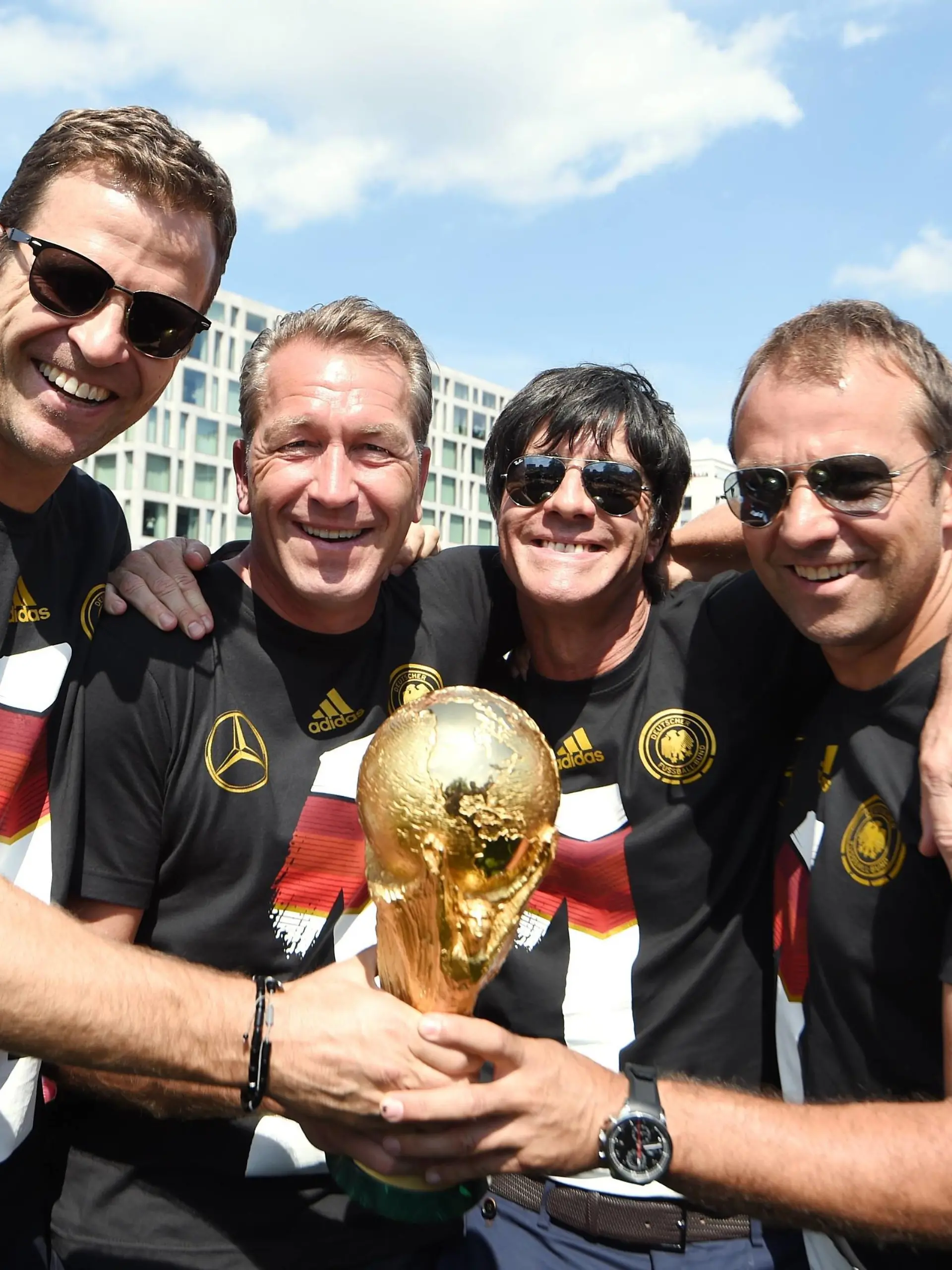Auf dem Truck: v.l.: Oliver BIERHOFF (Deutschland/Manager Nationalmannschaft), Torwarttrainer Andreas KÖPKE (Deutschland), Bundestrainer / Trainer Joachim Jogi LÖW (Deutschland), Assistenztrainer Hansi FLICK (Deutschland). Empfang/ WM-Party / Fahrt auf einem LKW / Truck zur Feier der deutschen Fussball Nationalmannschaft auf die Fanmeile am Brandenburger Tor in Berlin- FIFA - Fussball Weltmeisterschaft 2014, Fanmeile Berlin, Deutschland, 15.07.2014- WC party of the german national team men- FIFA- Soccer World Cup 2014  