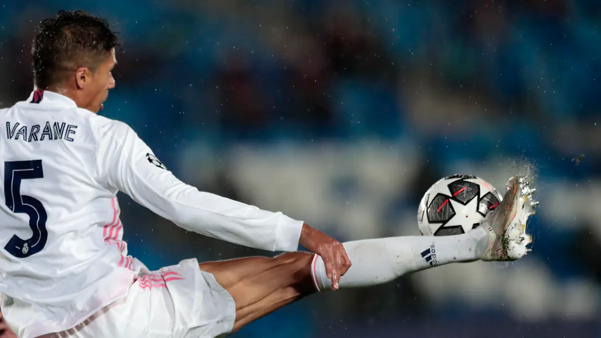 Real Madrid's Raphael Varane reaches for the ball during the Champions League semifinal first leg soccer match between Real Madrid and Chelsea at the Alfredo di Stefano stadium in Madrid, Spain, Tuesday, April 27, 2021. (AP Photo/Bernat Armangue)