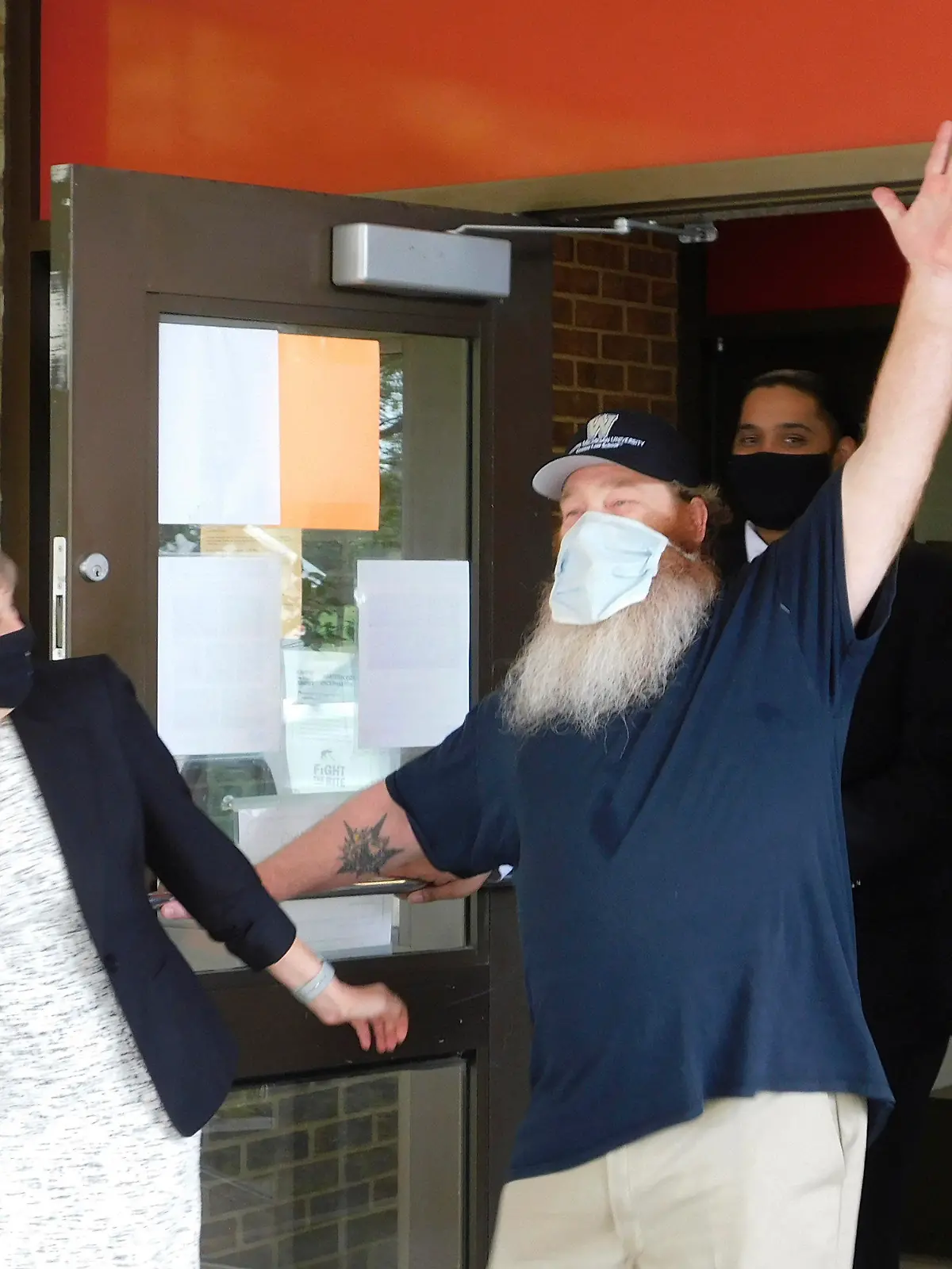 Gilbert Poole Jr., right, accompanied by attorney Marla Mitchell-Cichon, leaves prison in Jackson, Mich., Wednesday, May 26, 2021, after being exonerated of first-degree murder in Oakland County. Poole spent 32 years in prison. Authorities said he was wrongly convicted with unreliable evidence. (WMU-Cooley Law School via AP)
