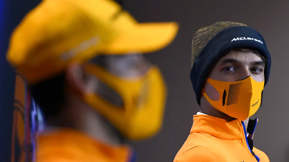 Mclaren driver Lando Norris of Britain looks at teammate Mclaren driver Daniel Ricciardo of Australia, left, during a news conference ahead of the Portugal Formula One Grand Prix at the Algarve International Circuit near Portimao, Portugal, Thursday, April 29, 2021. The Portugal Grand Prix will be held on Sunday. (Gabriel Buoys/Pool via AP)