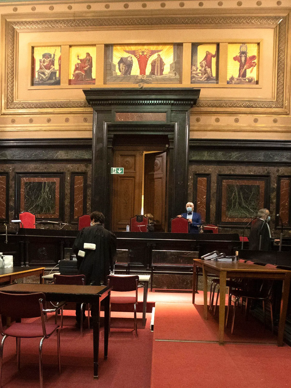 Lawyers for the European Commission, left, and AstraZeneca right, prepare arguments during a hearing, European Commission vs AstraZeneca, at the main courthouse in Brussels, Wednesday, May 26, 2021. While the EU insists AstraZeneca has breached its contractual obligations, the company says it has fully complied with the agreement, arguing that vaccines are difficult to manufacture and it made its best effort to deliver on time. the European Union's executive branch will try to persuade a Brussels court Wednesday that the case is urgent enough to justify ordering the company to make an immediate delivery of the missing shots. (AP Photo/Virginia Mayo)