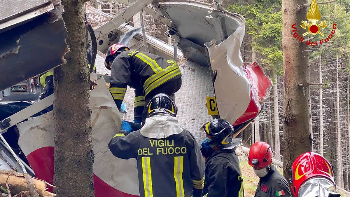 Rescuers work by the wreckage of a cable car after it collapsed near the summit of the Stresa-Mottarone line in the Piedmont region, northern Italy, Sunday, May 23, 2021. Italy’s transport minister was heading Monday, May 24, 2021 to the scene of a cable car disaster that killed 14 people when the lead cable apparently snapped and the cabin careened back down the mountain until it pulled off the line and crashed to the ground. (Vigili del Fuoco Firefighters via AP)