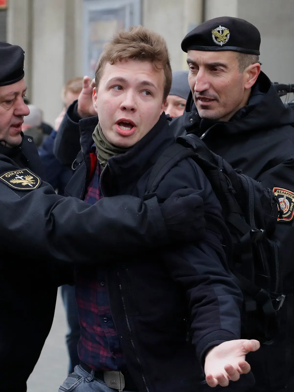 FILE - In this Sunday, March 26, 2017 file photo, Belarus police detain journalist Raman Pratasevich, center, in Minsk, Belarus. Raman Pratasevich, a founder of a messaging app channel that has been a key information conduit for opponents of Belarus’ authoritarian president, has been arrested after an airliner in which he was riding was diverted to Belarus because of a bomb threat. The presidential press service said President Alexander Lukashenko personally ordered that a MiG-29 fighter jet accompany the Ryanair plane — traveling from Athens, Greece, to Vilnius, Lithuania — to the Minsk airport. ﻿﻿(AP Photo/Sergei Grits, File)