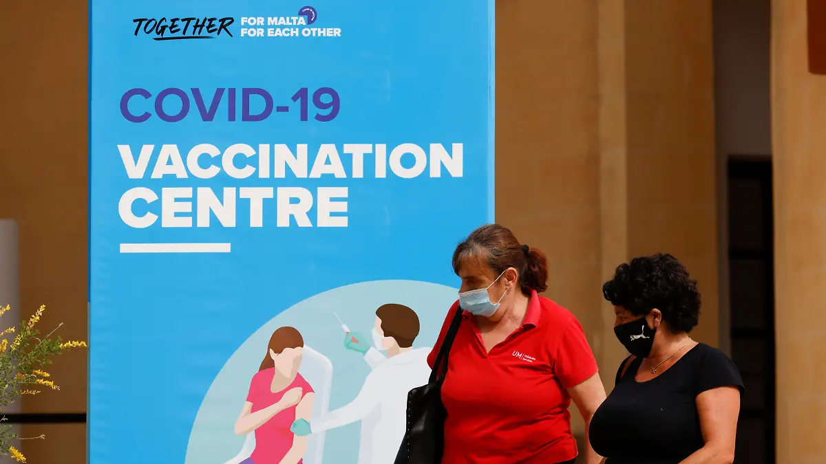 People walk outside a vaccination centre at the University of Malta, after authorities announced that Malta had achieved herd immunity with 70% of the population being receiving at least one vaccine dose against the coronavirus disease (COVID-19), in Msida, Malta May 24, 2021. REUTERS/Darrin Zammit Lupi