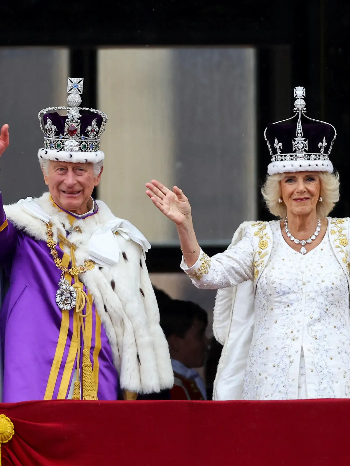 Britain's King Charles and Queen Camilla gesture as they stand on the Buckingham Palace balcony following their coronation ceremony in London, Britain May 6, 2023. REUTERS/Hannah McKay