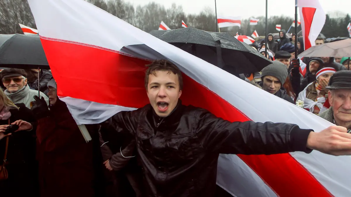 A prominent opponent of Belarus' authoritarian president Raman Pratasevich attends an opposition rally in Minsk, Belarus, Sunday, March 25, 2012. A prominent opponent of Belarus' authoritarian president has been arrested after the airliner in which he was traveling was diverted to the country after a bomb threat. The opposition and Western officials denounced the incident on Sunday, May 23, 2021 as a hijacking operation by the Belarus government. (AP Photo)