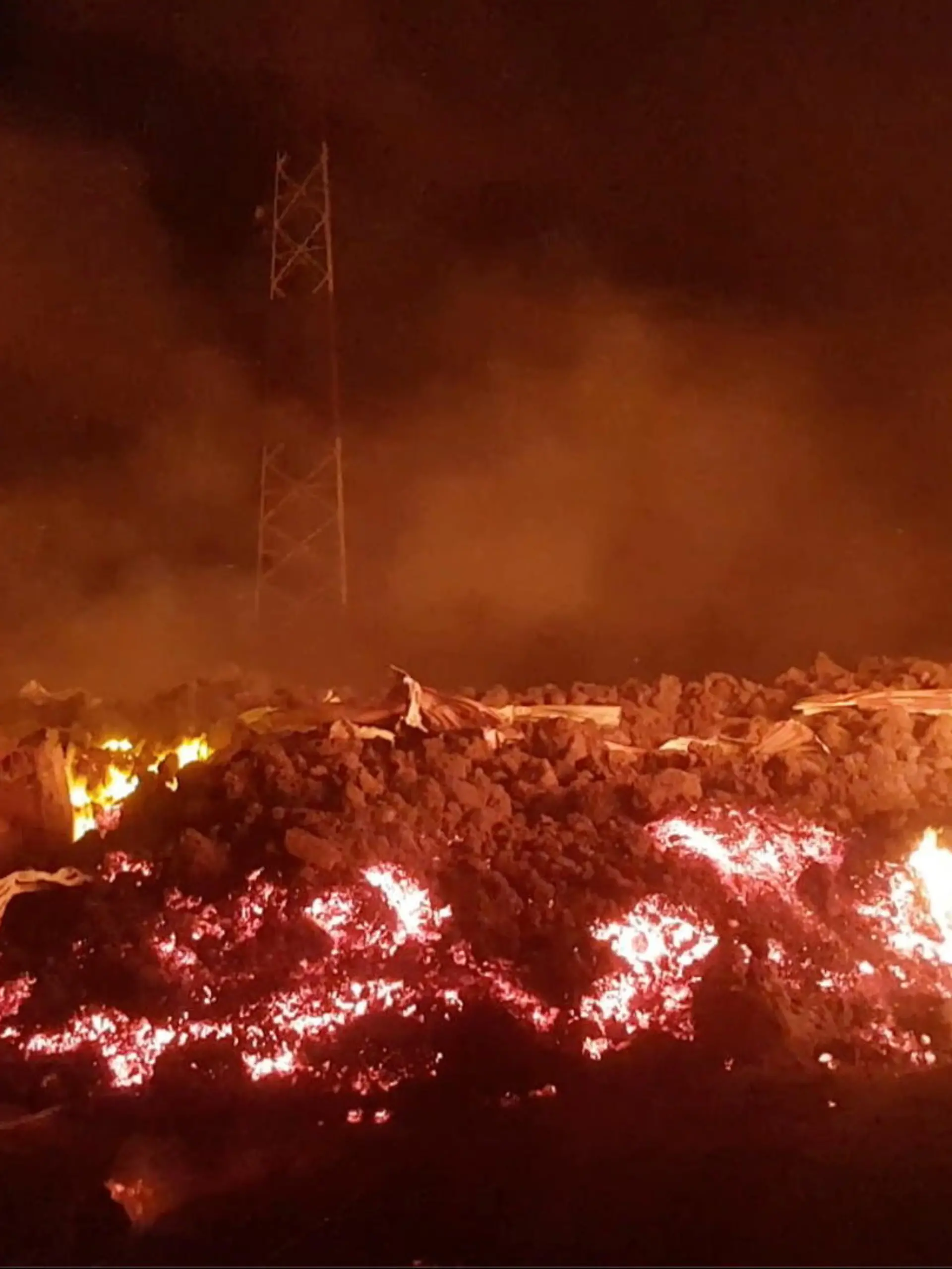 Flowing lava from the volcanic eruption of Mount Nyiragongo, which occurred late on May 22, 2021, is seen between buildings in Goma, Democratic Republic of Congo, in this still image from undated video obtained via social media. ENOCH DAVID via REUTERS ATTENTION EDITORS - THIS IMAGE HAS BEEN SUPPLIED BY A THIRD PARTY. MANDATORY CREDIT. NO RESALES. NO ARCHIVES.