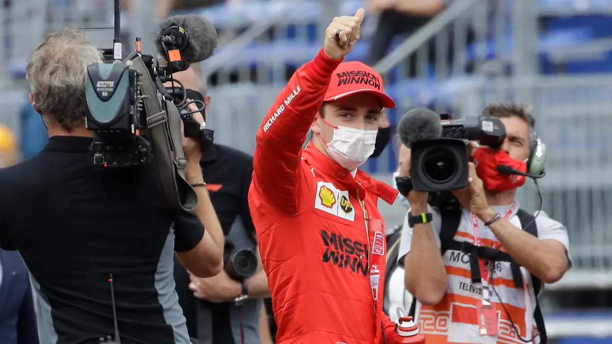 Ferrari driver Charles Leclerc of Monaco, center, gives the thumbs up after the qualifying session at the Monaco racetrack, in Monaco, Saturday, May 22, 2021. The Formula One race will take place on Sunday with Ferrari driver Charles Leclerc of Monaco in pole position. (AP Photo/Luca Bruno)