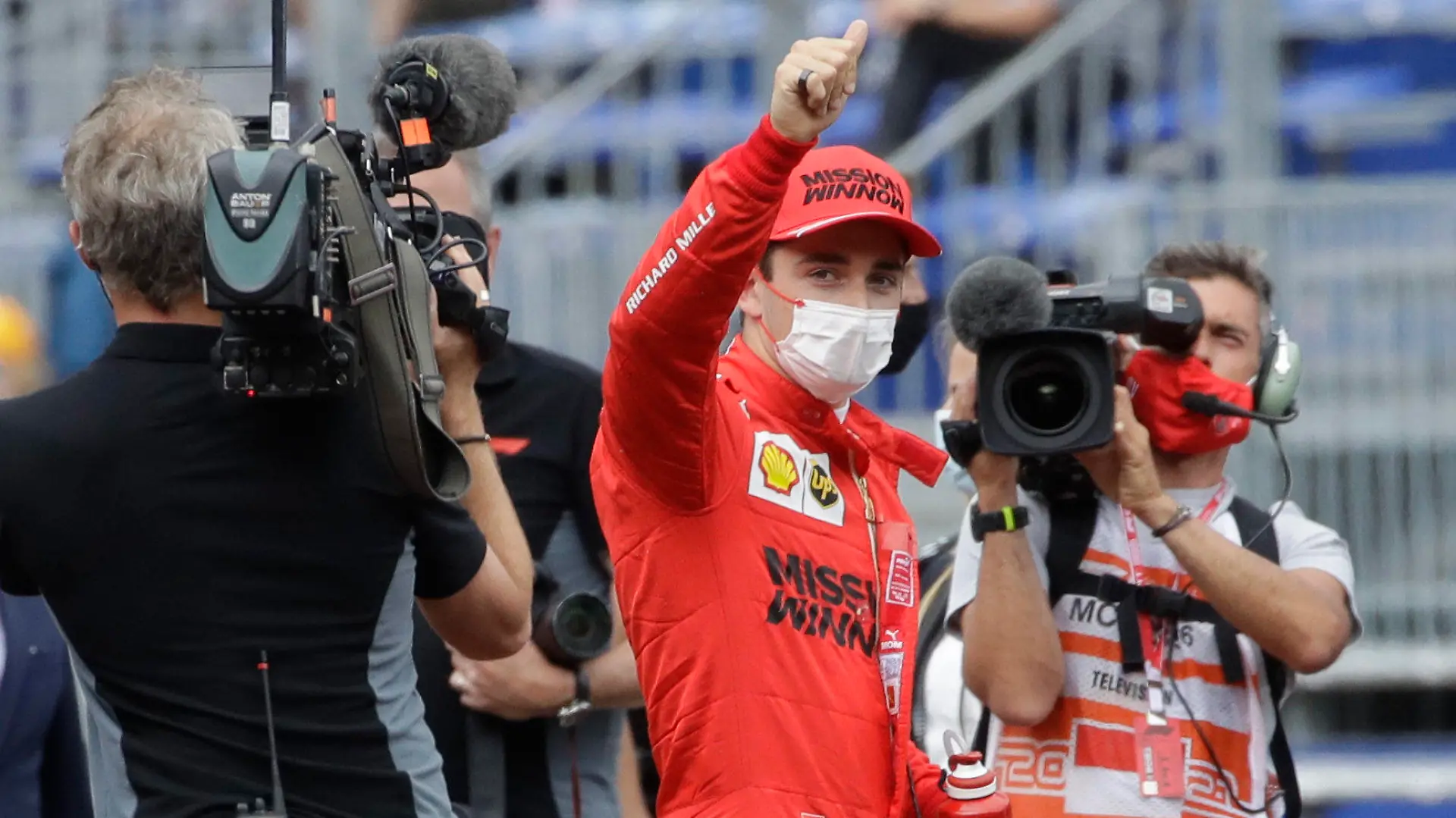 Ferrari driver Charles Leclerc of Monaco, center, gives the thumbs up after the qualifying session at the Monaco racetrack, in Monaco, Saturday, May 22, 2021. The Formula One race will take place on Sunday with Ferrari driver Charles Leclerc of Monaco in pole position. (AP Photo/Luca Bruno)