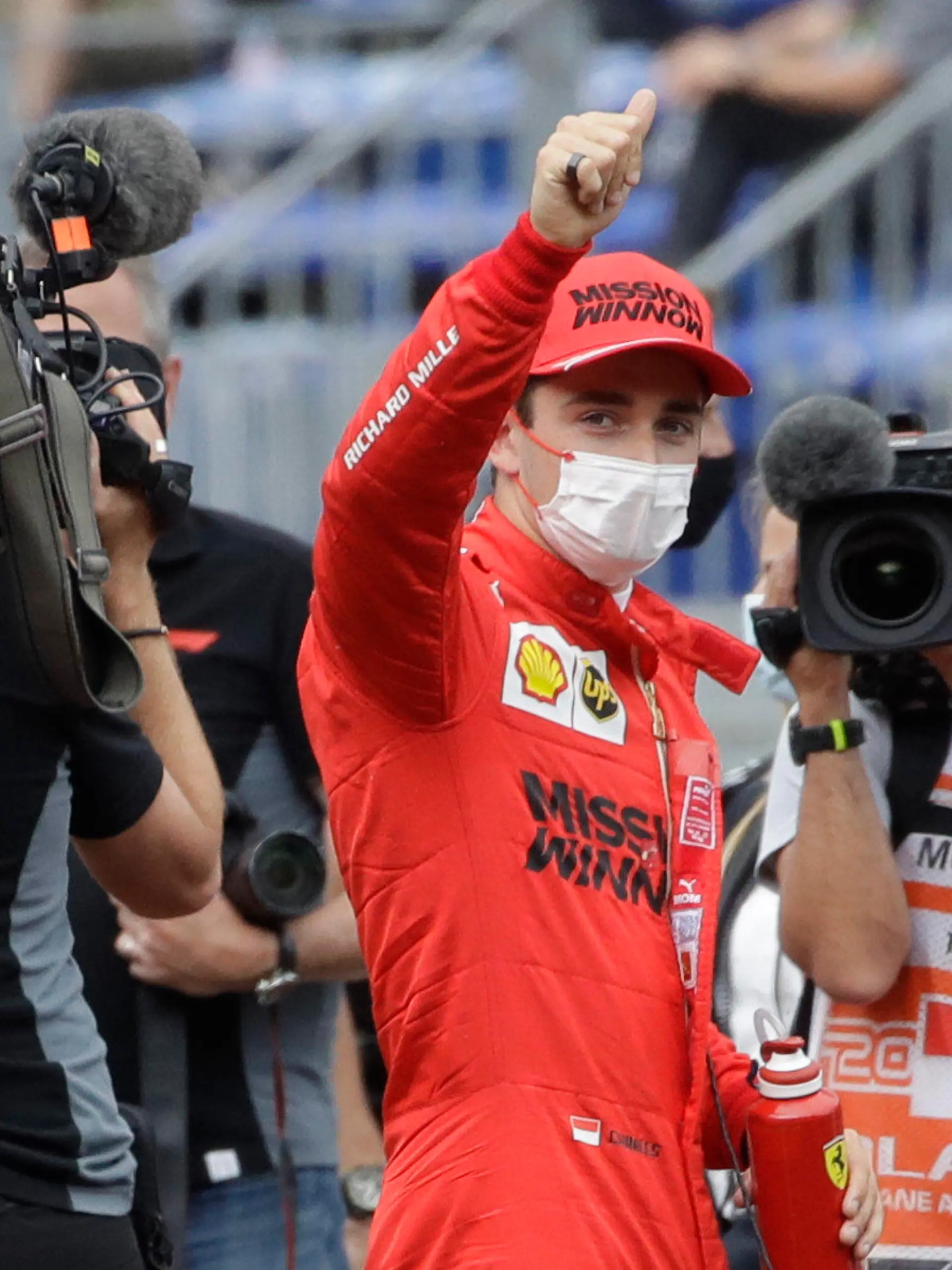 Ferrari driver Charles Leclerc of Monaco, center, gives the thumbs up after the qualifying session at the Monaco racetrack, in Monaco, Saturday, May 22, 2021. The Formula One race will take place on Sunday with Ferrari driver Charles Leclerc of Monaco in pole position. (AP Photo/Luca Bruno)