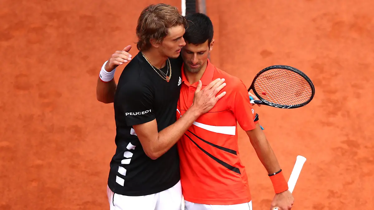 PARIS, FRANCE - JUNE 06: Novak Djokovic of Serbia embraces Alexander Zverev of Germany following their mens singles quarter-final match during Day twelve of the 2019 French Open at Roland Garros on June 06, 2019 in Paris, France. (Photo by Clive Brunskill/Getty Images)