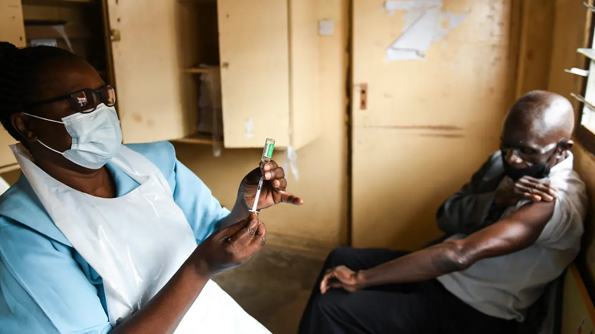 FILE - In this Monday, March 29, 2021 file photo, a man prepares for his AstraZeneca COVID-19 vaccine at Ndirande Health Centre in Blantyre, Malawi. Africa is "watching with total disbelief" as India struggles with a devastating resurgence in COVID-19 cases, the continent's top public health official said Thursday, April 29, 2021, as African officials worry about delays in vaccine deliveries caused by India's crisis. (AP Photo/Thoko Chikondi, File)