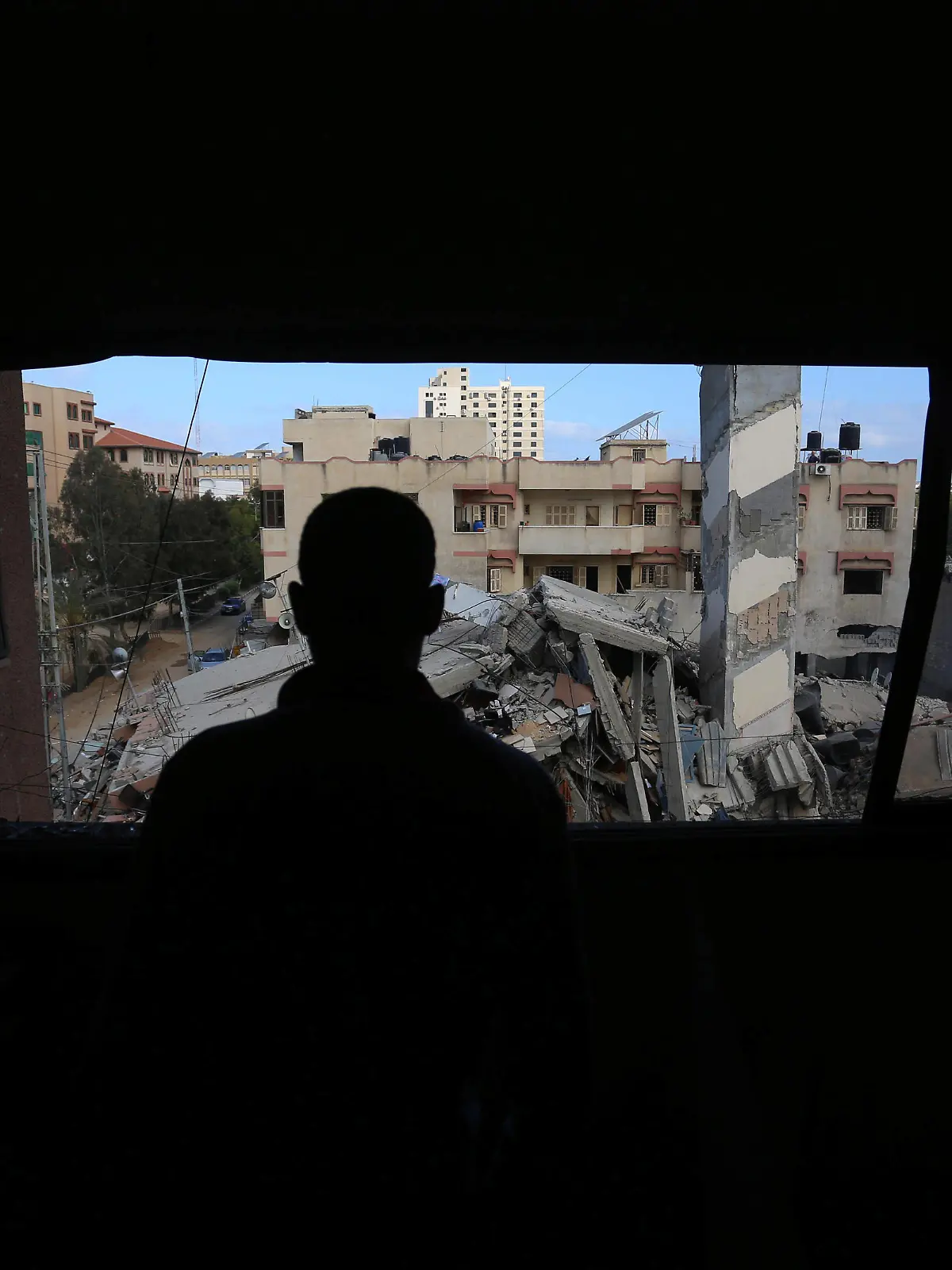  May 18, 2021, Gaza city, Gaza Strip, Palestinian Territory: Palestinians look for salvageable items amid the rubbe of the six-storey Kuhail building which was destroyed in an early morning Israeli airstrike on Gaza City. The UN Security Council was due to hold an emergency meeting today amid a flurry of urgent diplomacy aimed at stemming Israel air strikes that have killed more than 200 Palestinians Gaza city Palestinian Territory - ZUMAap3_ 20210518_zaf_ap3_064 Copyright: xAshrafxAmrax