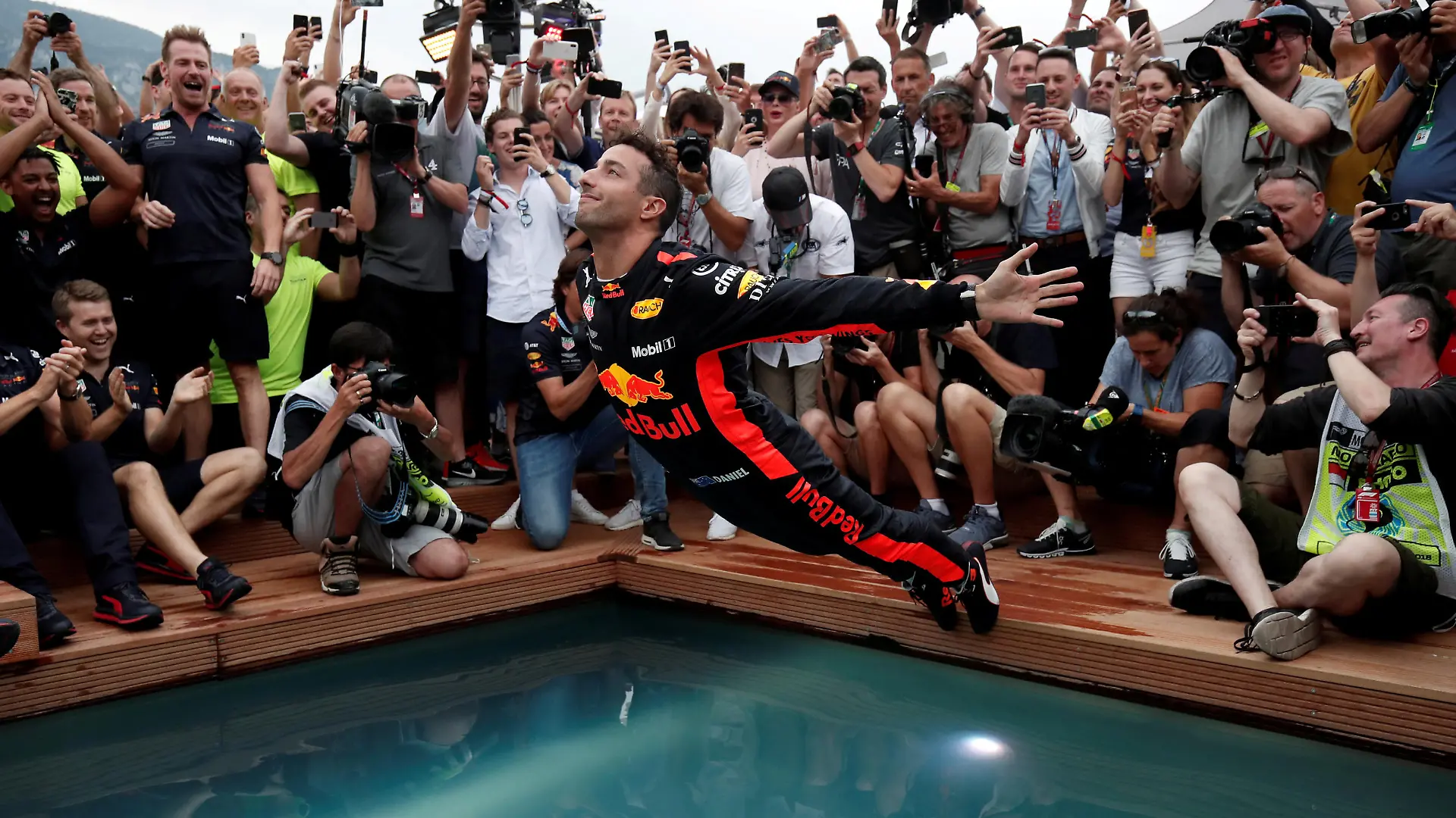 Formula One F1 - Monaco Grand Prix - Circuit de Monaco, Monte Carlo, Monaco - May 27, 2018 Red Bull's Daniel Ricciardo jumps into a pool as he celebrates winning the race REUTERS/Benoit Tessier TPX IMAGES OF THE DAY