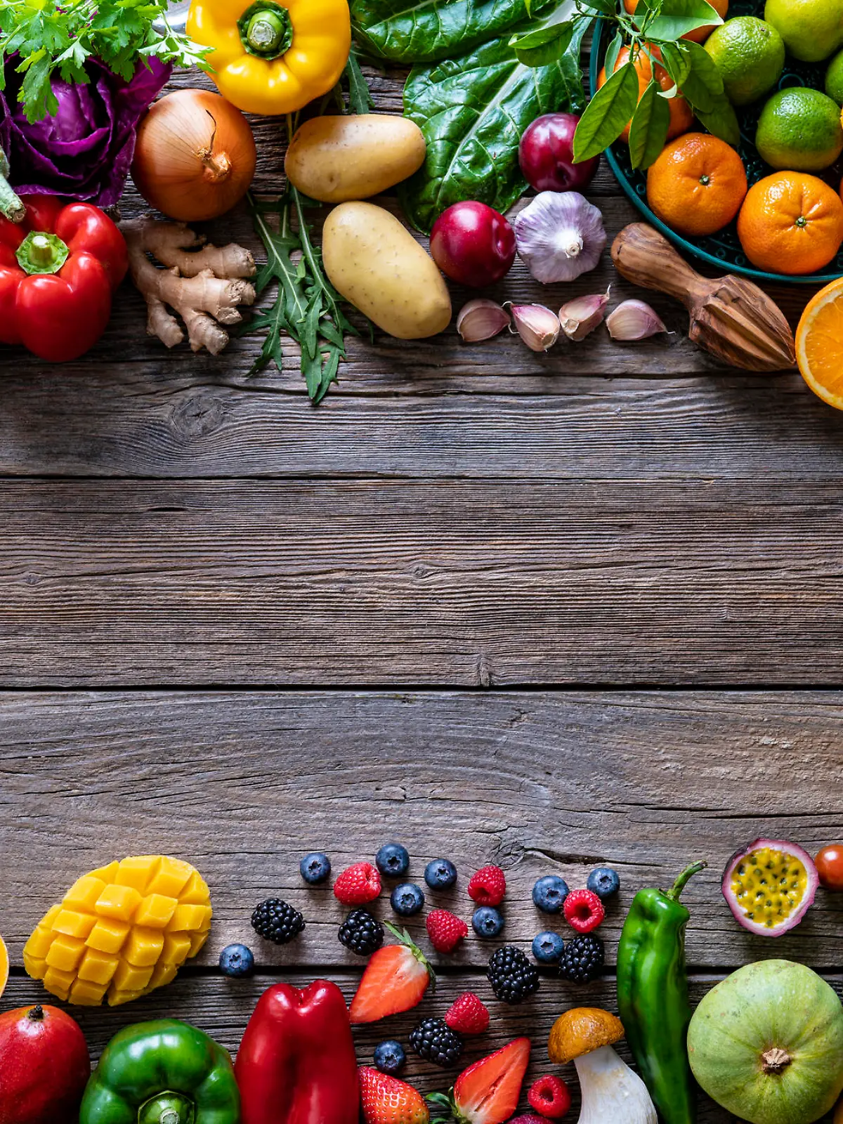 Vegetables and fruits vegan food assorted arrangement varied leaving rustic wood copy space background