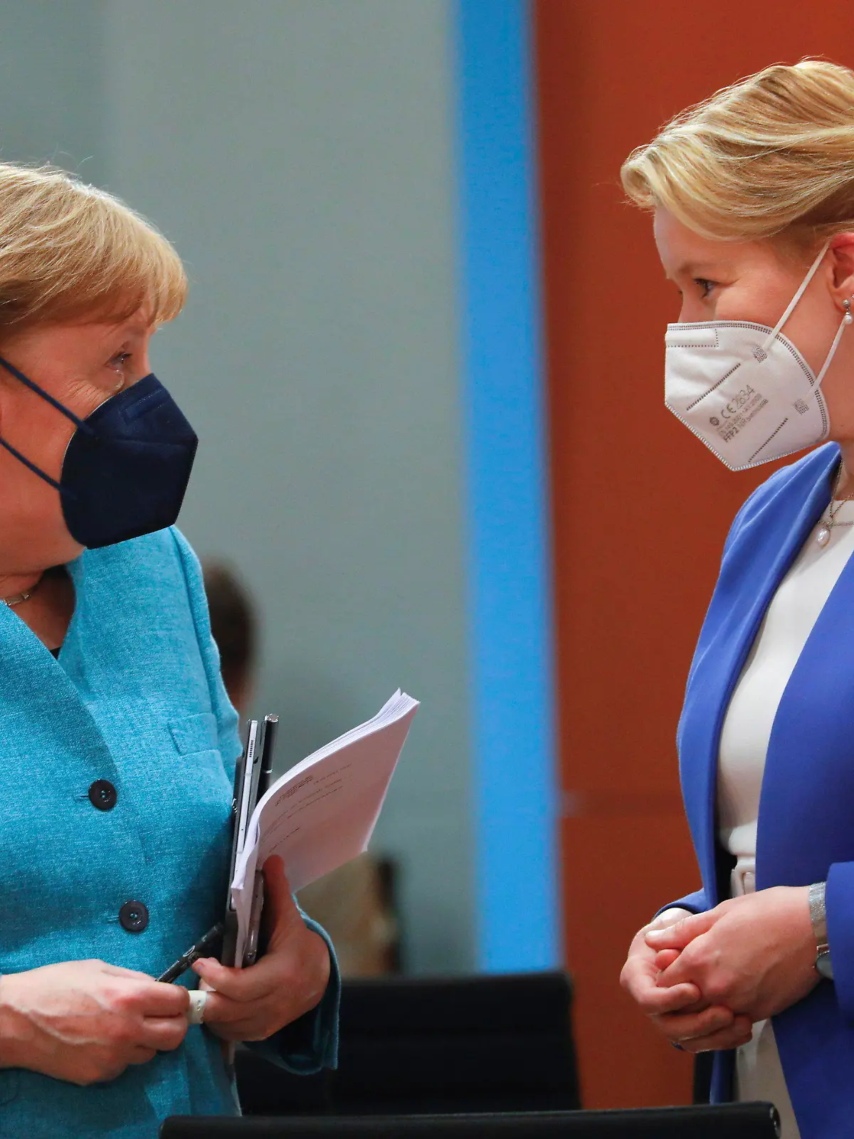 German Chancellor Angela Merkel speaks with German Minister for Family Affairs, Senior Citizens, Women and Youth, Franziska Giffey as she arrives at the weekly cabinet meeting at the Chancellery in Berlin, Germany, Wednesday, May 19, 2021. Franziska Giffey announced her resignation as a federal minister as a long-running controversy over allegations of plagiarism in her doctoral thesis nears its conclusion. (Michele Tantussi/Pool via AP)