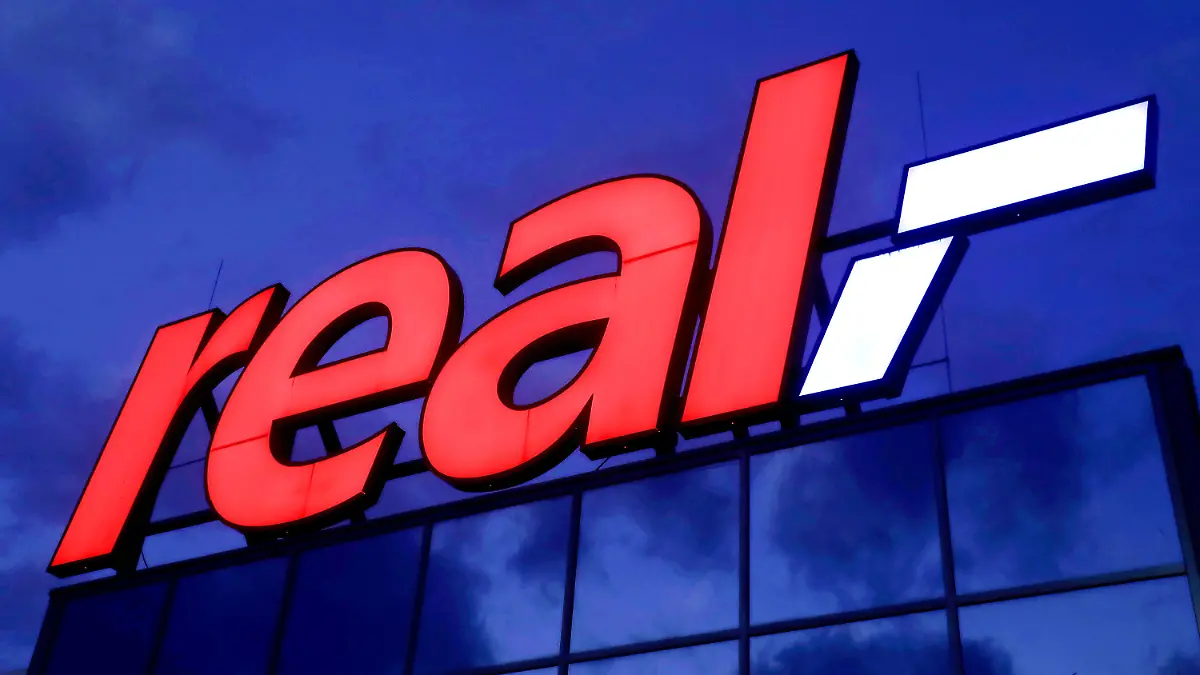 ARCHIV - 17.01.2020, Nordrhein-Westfalen, Köln: Das Logo leuchtet am Morgen auf dem Dach eines Real Warenhauses.     (zu dpa "Kartellamt erlaubt Übernahme von 92 Real-Märkten durch Kaufland") Foto: Oliver Berg/dpa +++ dpa-Bildfunk +++