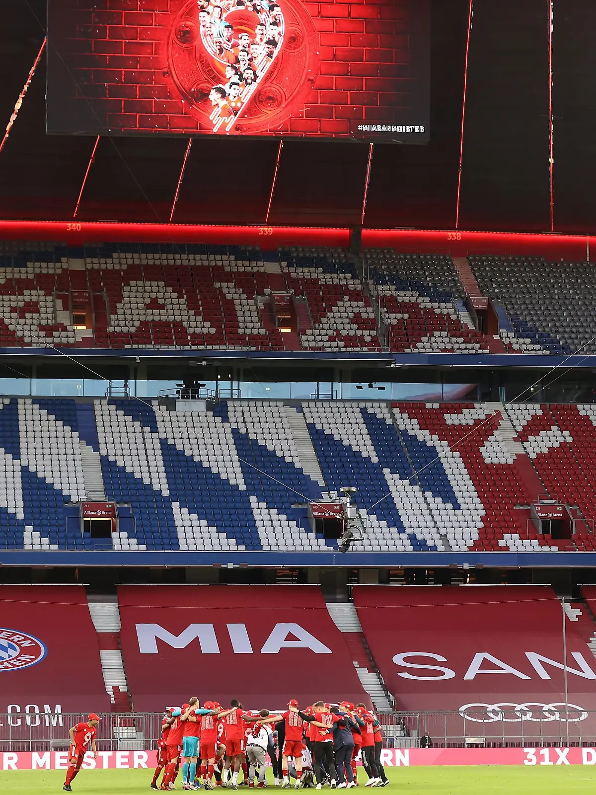 MUNICH, GERMANY - MAY 08: Players and staff of FC Bayern Muenchen celebrate winning the Bundesliga title after the Bundesliga match between FC Bayern Muenchen and Borussia Moenchengladbach at Allianz Arena on May 08, 2021 in Munich, Germany. Sporting stadiums around Germany remain under strict restrictions due to the Coronavirus Pandemic as Government social distancing laws prohibit fans inside venues resulting in games being played behind closed doors. (Photo by Alexander Hassenstein/Getty Images)