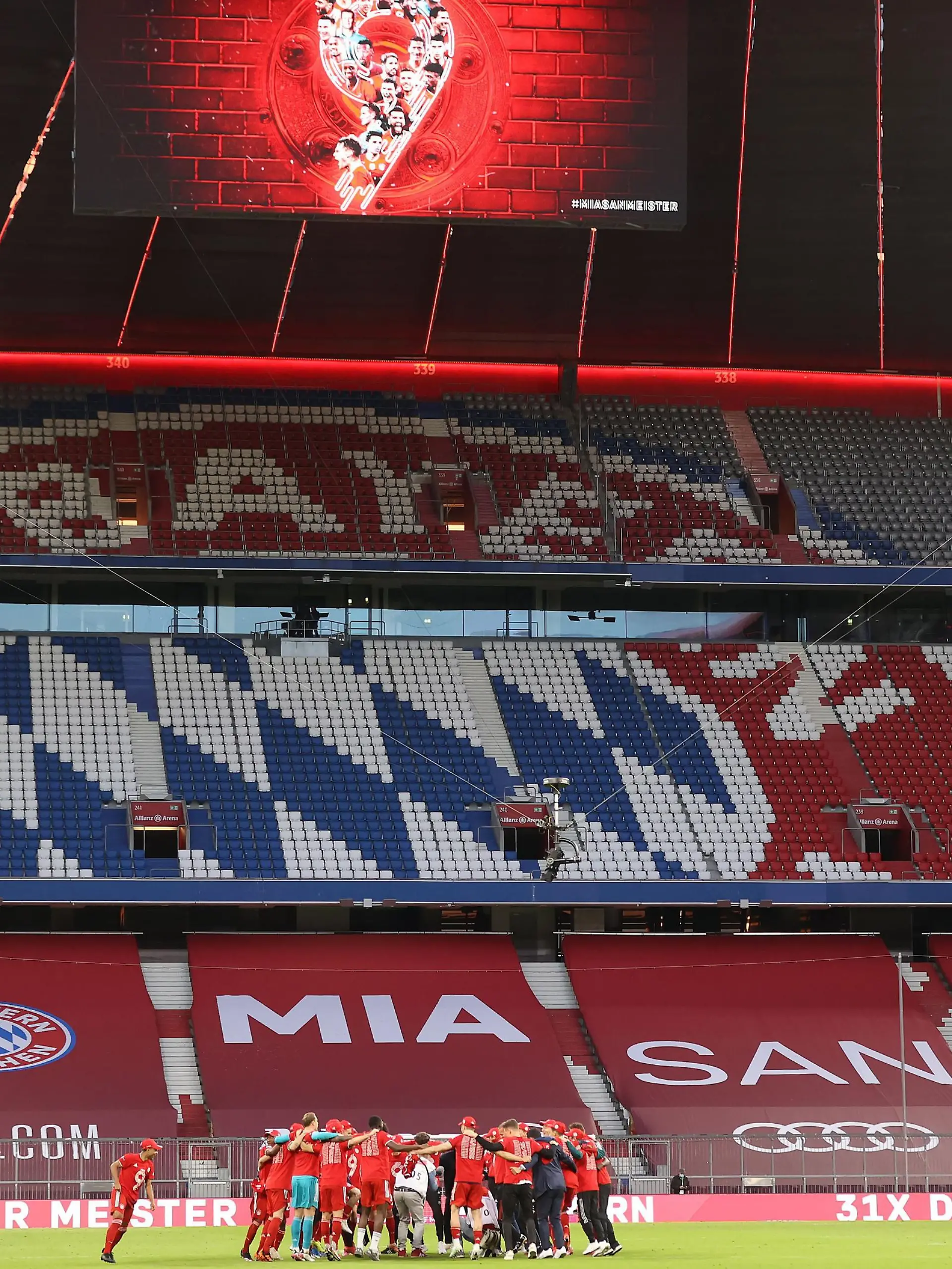 MUNICH, GERMANY - MAY 08: Players and staff of FC Bayern Muenchen celebrate winning the Bundesliga title after the Bundesliga match between FC Bayern Muenchen and Borussia Moenchengladbach at Allianz Arena on May 08, 2021 in Munich, Germany. Sporting stadiums around Germany remain under strict restrictions due to the Coronavirus Pandemic as Government social distancing laws prohibit fans inside venues resulting in games being played behind closed doors. (Photo by Alexander Hassenstein/Getty Images)
