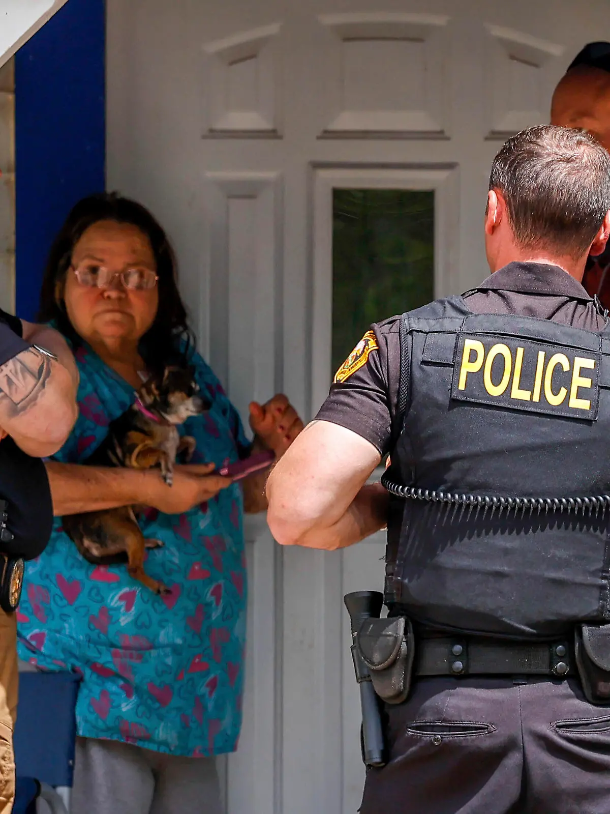 Henryetta Police Chief Steve Norman,left, visits the home of Nathan Brewer in Henryetta Okla., on Wednesday, May 3, 2023. Brittany Brewer was found dead at a home in Henryetta along with six others on Monday. Jesse McFadden, an Oklahoma sex offender who was released from prison early shot his wife, her three children and their two friends in the head and then killed himself, authorities confirmed Wednesday as concerns grew about why he was free in the first place. (Nathan J. Fish/The Oklahoman via AP)