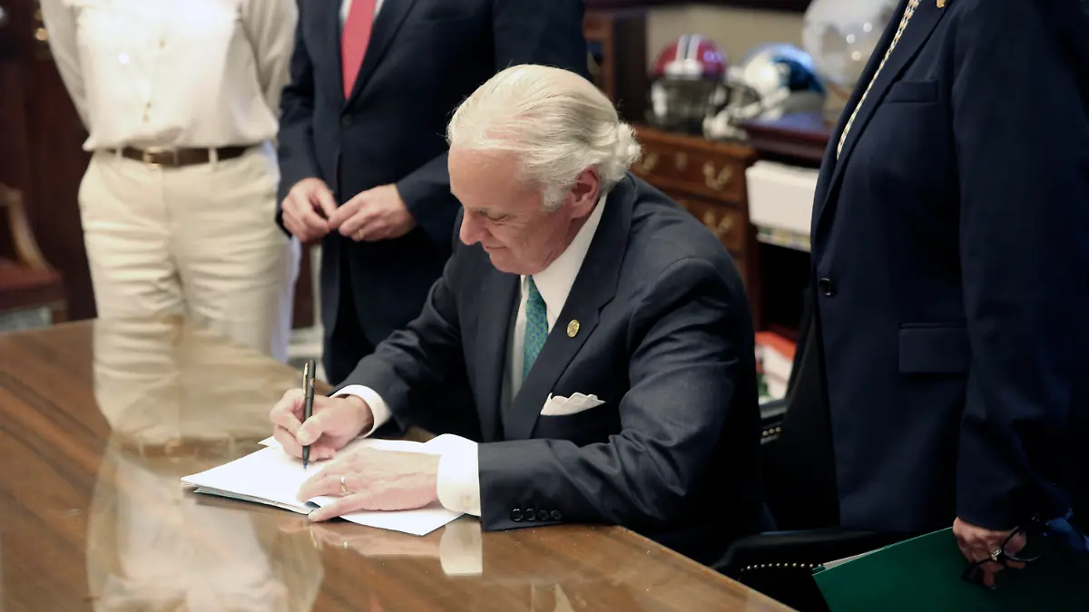 South Carolina Gov. Henry McMaster signs a bill requiring schools to provide in-person classes five days a week starting April 26 and for next school year on Thursday, April 22, 2021, in Columbia, S.C. The bill also requires school districts to pay teachers extra if they have to teach both in person and online. (AP Photo/Jeffrey Collins)