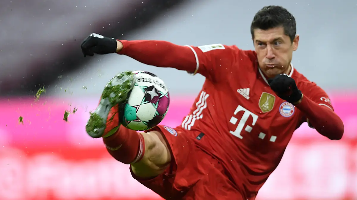 ARCHIV - 15.02.2021, Bayern, München: Der Fußballer Robert Lewandowski, vom FC Bayern München, spielt den Ball im eigenen Stadion. Lewandowski will bei der Jagd nach dem alleinigen Torrekord in der Fußball-Bundesliga keine Chance auslassen und würde für den 41. Saisontreffer auch einen Elfmeter in der 90. Minute schießen. Foto: Andreas Schaad/AP-Pool/dpa - WICHTIGER HINWEIS: Gemäß den Vorgaben der DFL Deutsche Fußball Liga bzw. des DFB Deutscher Fußball-Bund ist es untersagt, in dem Stadion und/oder vom Spiel angefertigte Fotoaufnahmen in Form von Sequenzbildern und/oder videoähnlichen Fotostrecken zu verwerten bzw. verwerten zu lassen. +++ dpa-Bildfunk +++