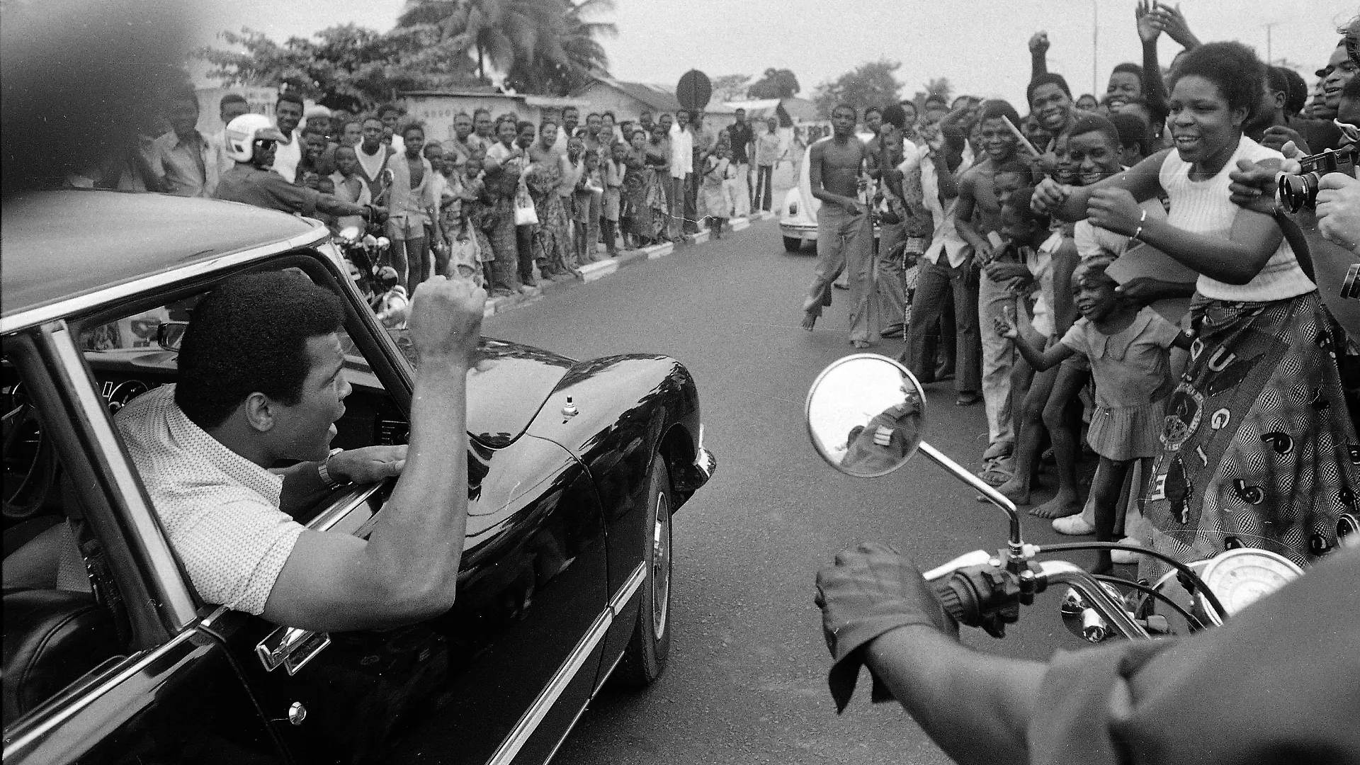 Muhammad Ali is cheered by Zaire admirers as he drives in downtown Kinshasa for a sightseeing trip, Sept. 17, 1974. Ali is in Zaire to face George Foreman. (AP Photo)