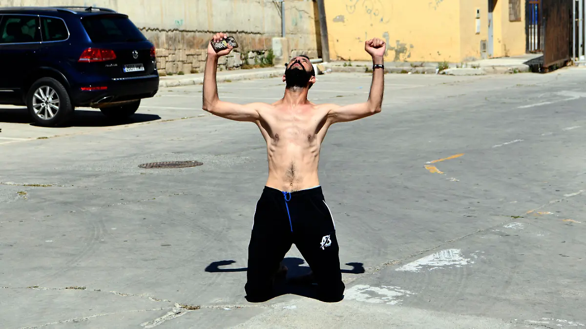 A man from Morocco reacts after entering swimming into the Spanish territory, at the Spanish enclave of Ceuta on Monday, May 17, 2021. Authorities in Spain say that around 1,000 Moroccan migrants have crossed into Spanish territory (Antonio Sempere/Europa Press via AP)