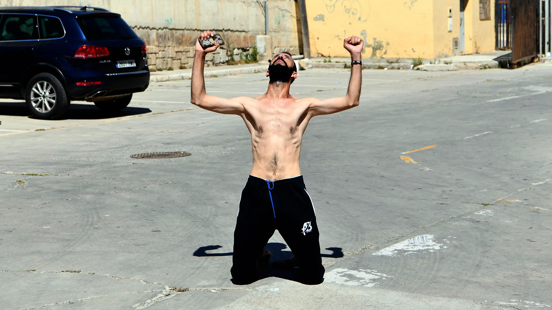 A man from Morocco reacts after entering swimming into the Spanish territory, at the Spanish enclave of Ceuta on Monday, May 17, 2021. Authorities in Spain say that around 1,000 Moroccan migrants have crossed into Spanish territory (Antonio Sempere/Europa Press via AP)