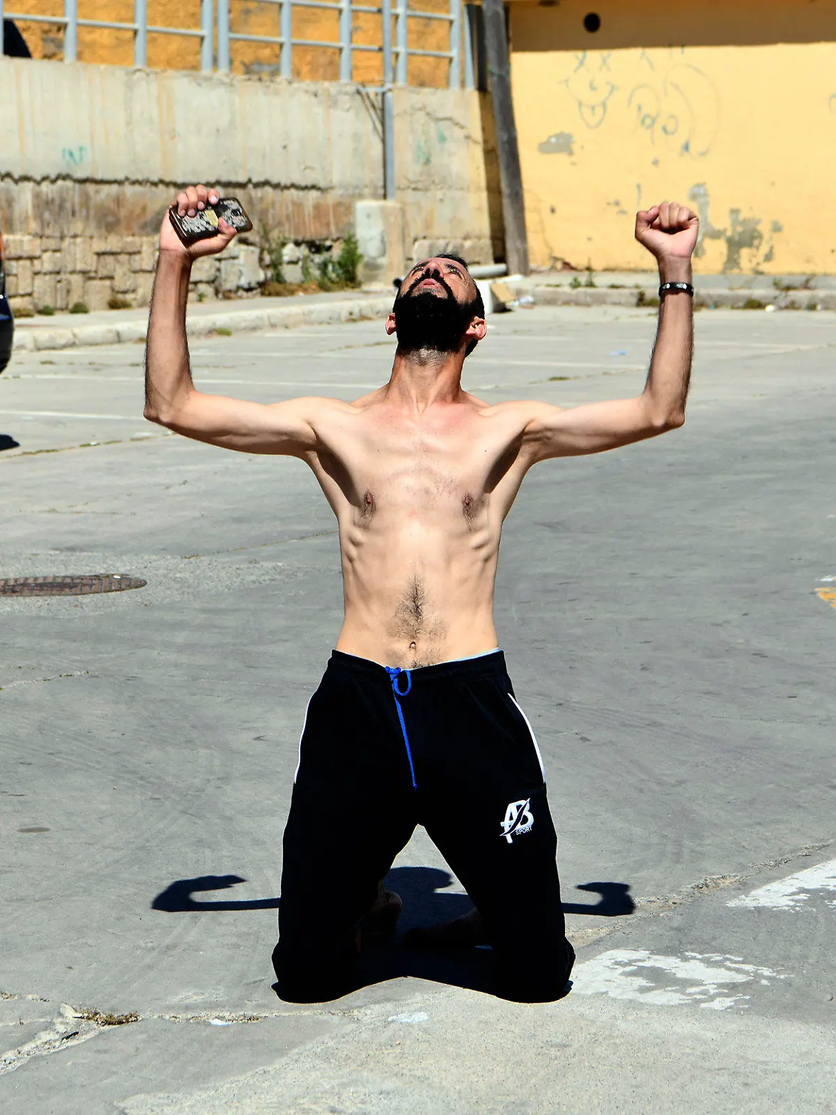 A man from Morocco reacts after entering swimming into the Spanish territory, at the Spanish enclave of Ceuta on Monday, May 17, 2021. Authorities in Spain say that around 1,000 Moroccan migrants have crossed into Spanish territory (Antonio Sempere/Europa Press via AP)