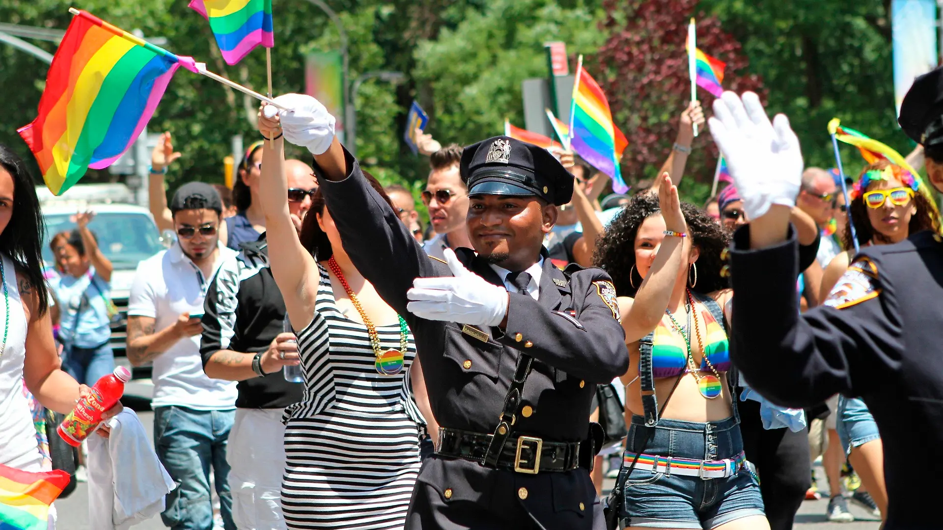 FILE - In this Sunday, June 29, 2014 file photo, NYPD police officers march along Fifth Avenue during the gay pride parade in New York. Organizers of New York City’s Pride events said Saturday, May 15, 2021 they are banning police and other law enforcement from marching in their huge annual parade until at least 2025 and will also seek to keep on-duty officers a block away from the celebration of LGBTQ people and history. (AP Photo/Julia Weeks, File)