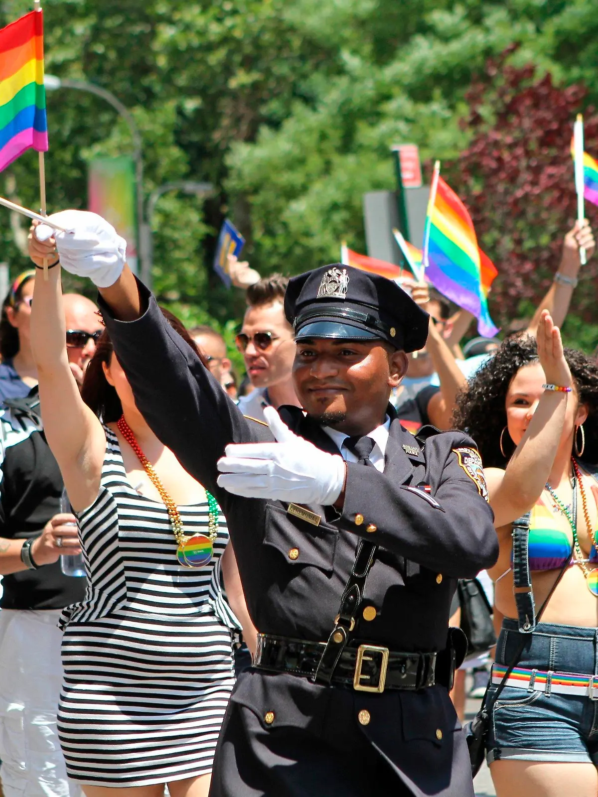 FILE - In this Sunday, June 29, 2014 file photo, NYPD police officers march along Fifth Avenue during the gay pride parade in New York.  Organizers of New York City’s Pride events said Saturday, May 15, 2021 they are banning police and other law enforcement from marching in their huge annual parade until at least 2025 and will also seek to keep on-duty officers a block away from the celebration of LGBTQ people and history. (AP Photo/Julia Weeks, File)