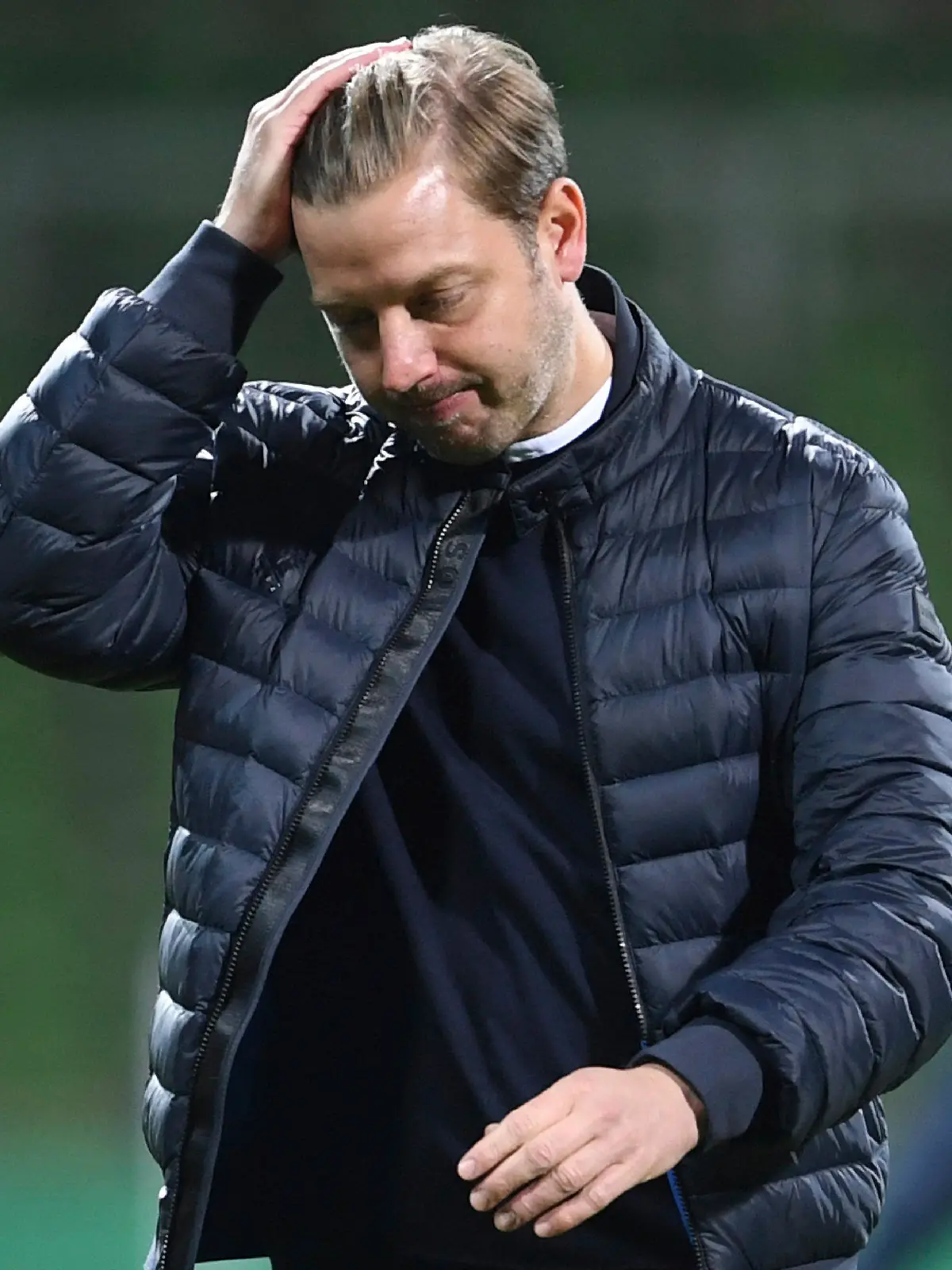 FILE-In this May 1, 2021 taken photo Bremen's head coach Florian Kohfeldt walks in dejection end of the German soccer cup semifinal soccer match between Werder Bremen and RB Leipzig at the Weserstadion stadium in Bremen, Germany. Werder Bremen has fired coach Florian Kohfeldt one match day before the end of the season. Former coach Thomas Schaaf will coach the team until the end of the season.(Carmen Jaspersen/Pool Photo via AP)