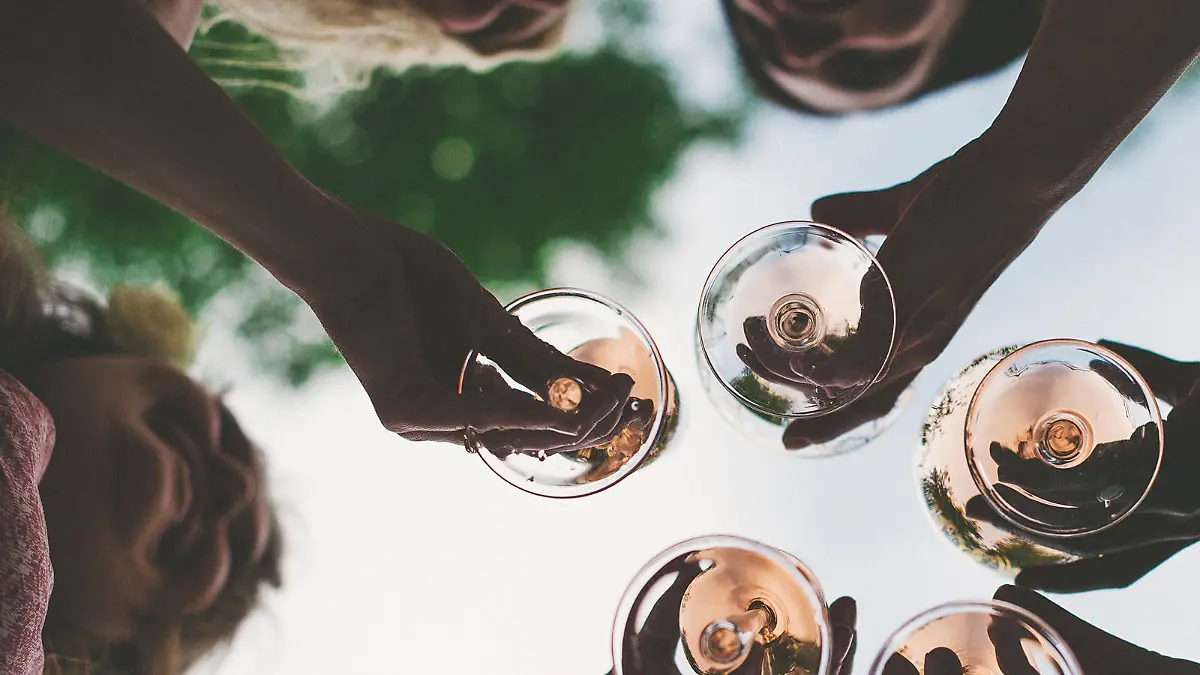 Woman toasting with sparkling wine and champagne