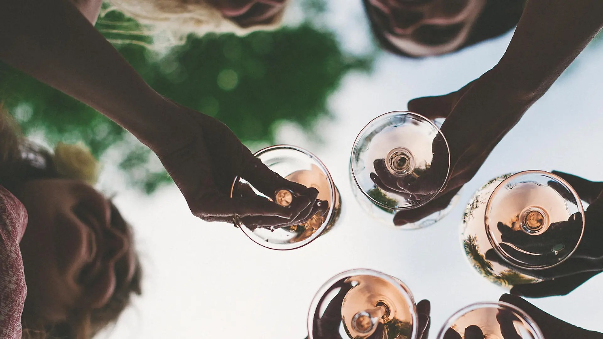 Woman toasting with sparkling wine and champagne