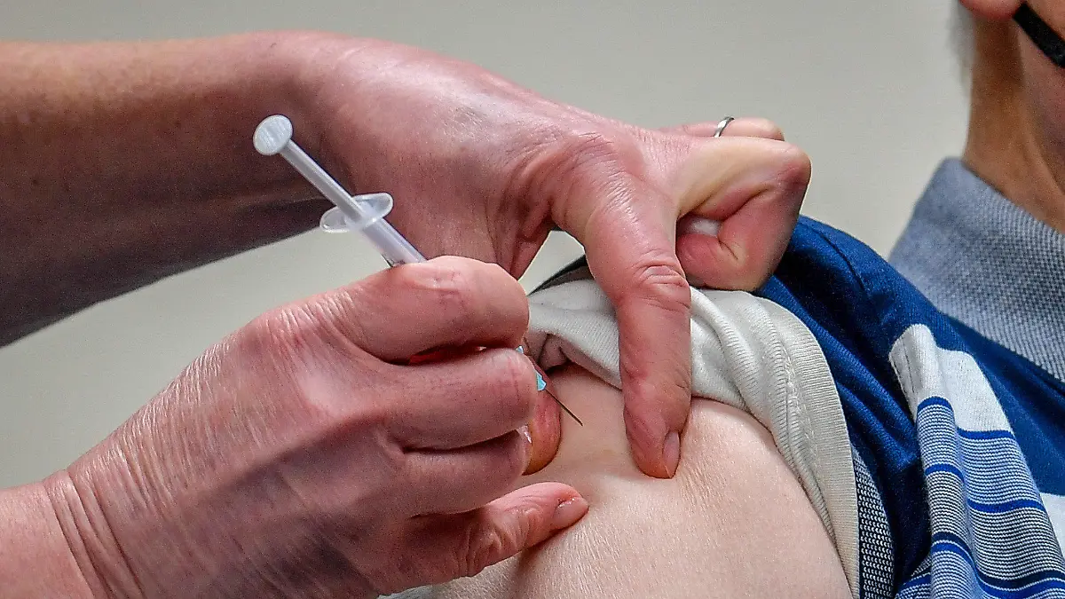 ARCHIV - 04.01.2021, Großbritannien, Merthyr Tydfil: Ein Patient wird mit dem von der Universität Oxford und dem Pharmakonzern Astrazeneca produzierten Corona-Impfstoffs in der Arztpraxis Pontcae geimpft. Wer zwei unterschiedliche Corona-Impfstoffe bei seiner Erst- und Zweitimpfung erhält, hat mit höherer Wahrscheinlichkeit milde und moderate Nebenwirkungen nach der zweiten Dosis. (zu dpa «Studie: Nebenwirkungen bei gemischter Corona-Impfung etwas häufiger») Foto: Ben Birchall/PA Wire/dpa +++ dpa-Bildfunk +++