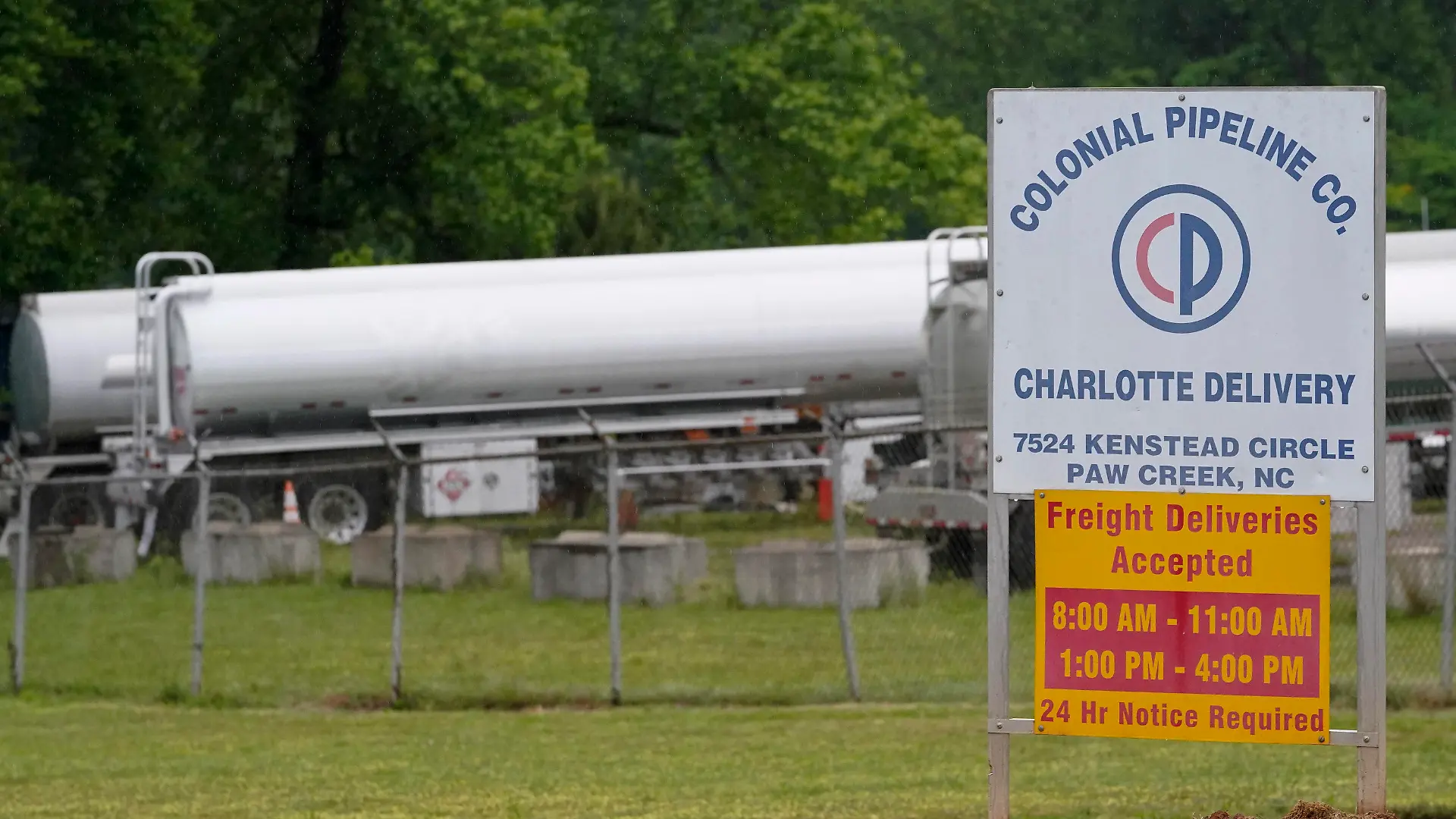 Tanker trucks are parked near the entrance of Colonial Pipeline Company Wednesday, May 12, 2021, in Charlotte, N.C. Several gas stations in the Southeast reported running out of fuel, primarily because of what analysts say is unwarranted panic-buying among drivers, as the shutdown of a major pipeline by hackers entered its fifth day. (AP Photo/Chris Carlson)