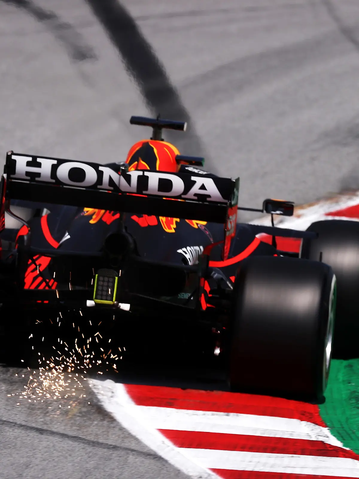 BARCELONA, SPAIN - MAY 07: Sparks fly behind the car of Max Verstappen of the Netherlands driving the (33) Red Bull Racing RB16B Honda on track during practice for the F1 Grand Prix of Spain at Circuit de Barcelona-Catalunya on May 07, 2021 in Barcelona, Spain. (Photo by Lars Baron/Getty Images)