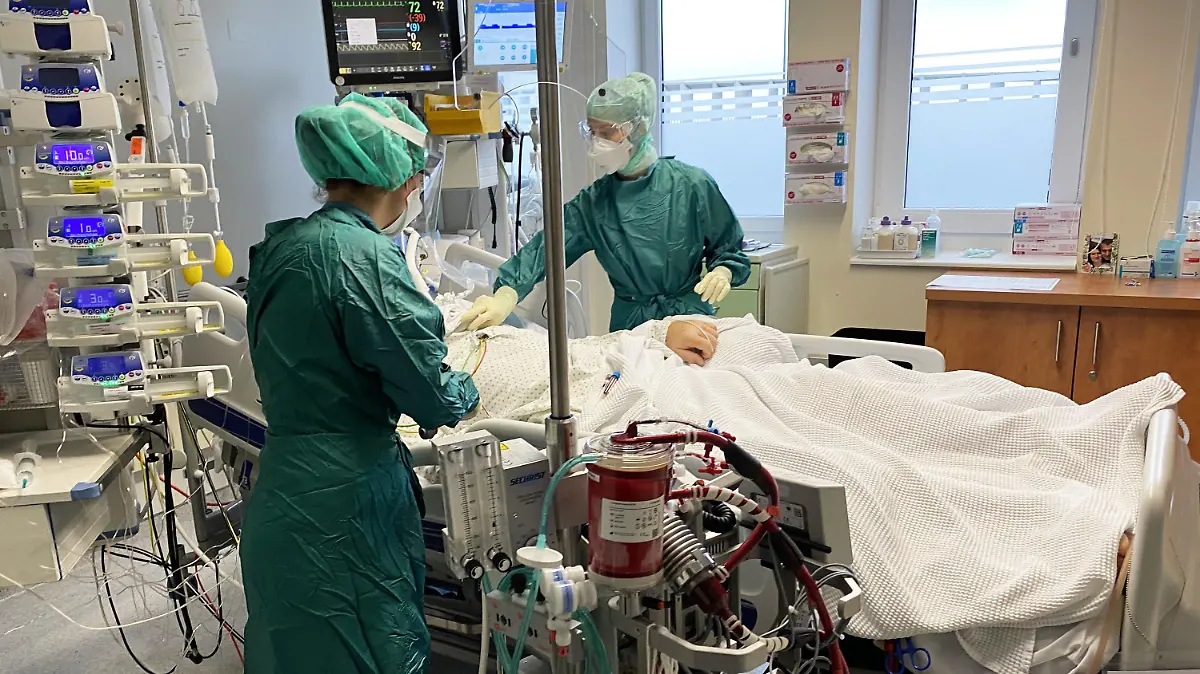 HANDOUT - 03.11.2020, Österreich, Salzburg: Medizinische Mitarbeiter der am Uniklinikum behandeln einen Patienten auf der intrinsischen Intensivstation. Aufgrund des starken Anstieg der Patientin, die am Coronavirus erkrankt sind, kommen die Intensivstationen landesweit an ihre Grenzen. Foto: Unbekannt/SALK/APA/dpa +++ dpa-Bildfunk +++
