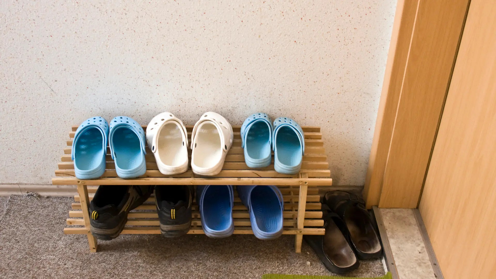 Schuhe im Hausflur vor einer Eingangstür
