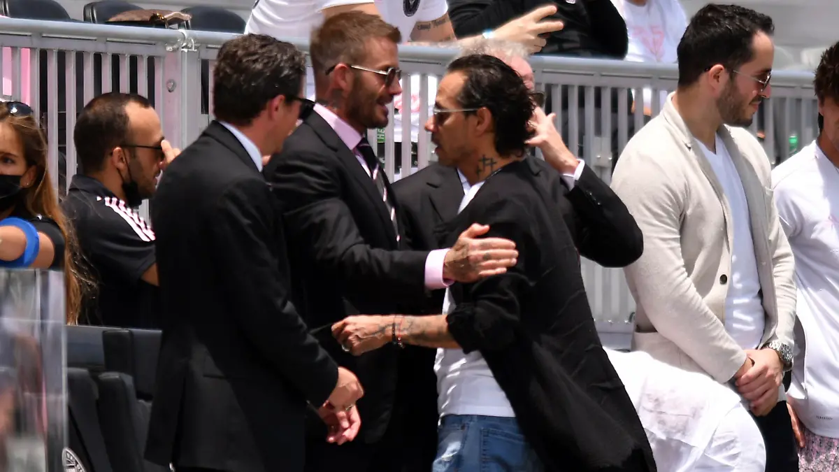 David Beckham, center left, owner and president of soccer operations for Inter Miami, greets artist Marc Anthony, center right, before an MLS soccer match between Inter Miami and Atlanta United, Sunday, May 9, 2021, in Fort Lauderdale, Fla. (AP Photo/Jim Rassol)
