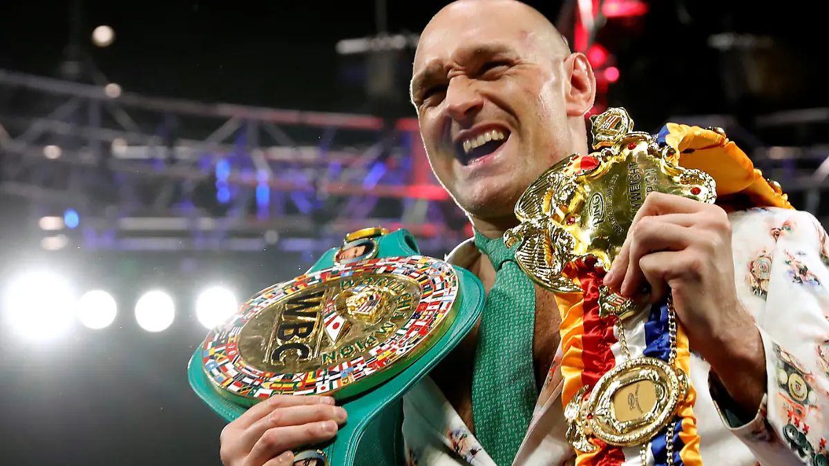 FILE PHOTO: Boxing - Deontay Wilder v Tyson Fury - WBC Heavyweight Title - The Grand Garden Arena at MGM Grand, Las Vegas, United States - February 22, 2020 Tyson Fury poses with his belts during a press conference after the fight REUTERS/Steve Marcus/File Photo